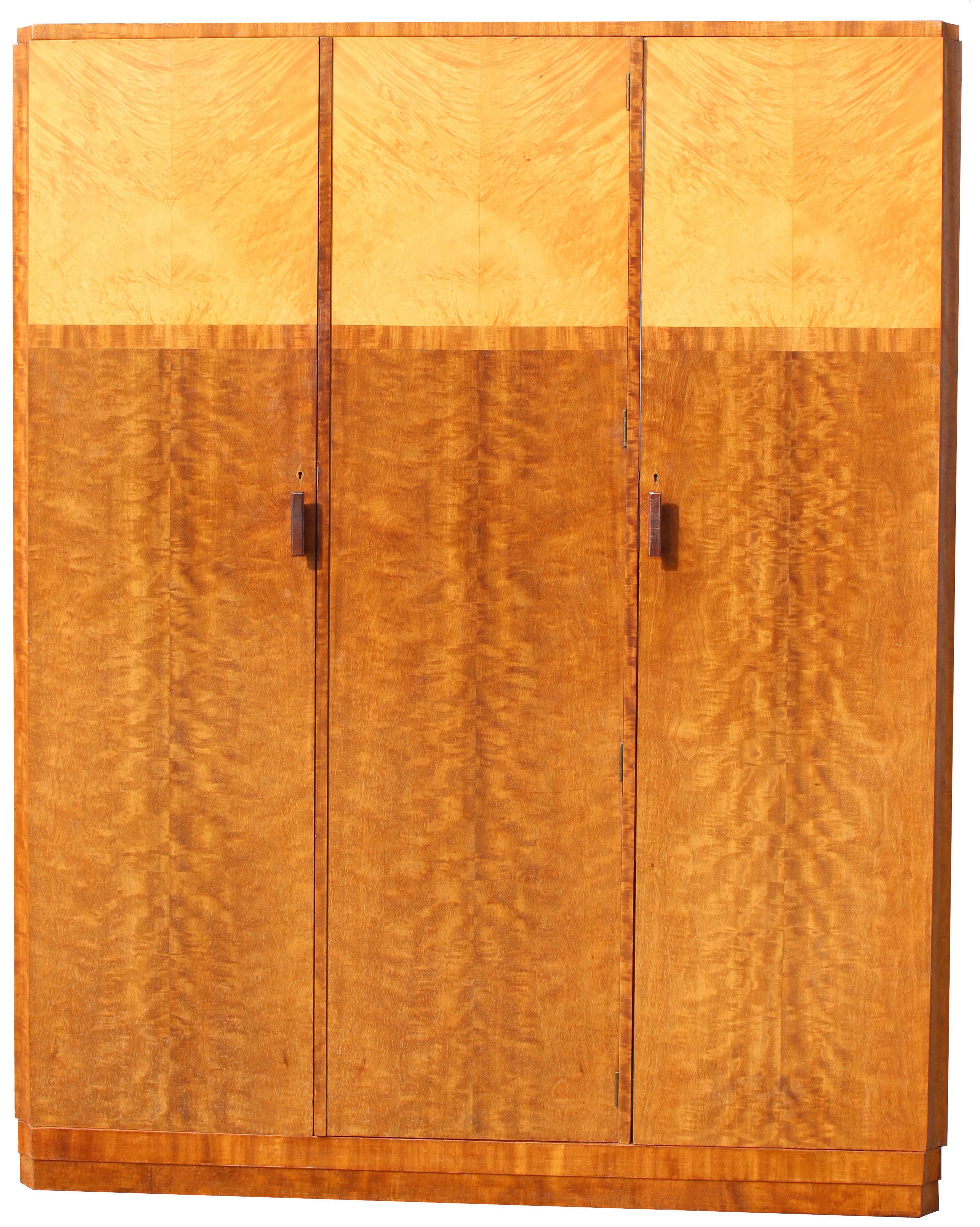 For your consideration is this very high quality two tone triple wardrobe in fiddle grain Mahogany and pale blonde Maple veneers with walnut feather banding as a border. This beautiful wardrobe exudes quality and style and offers a very generous