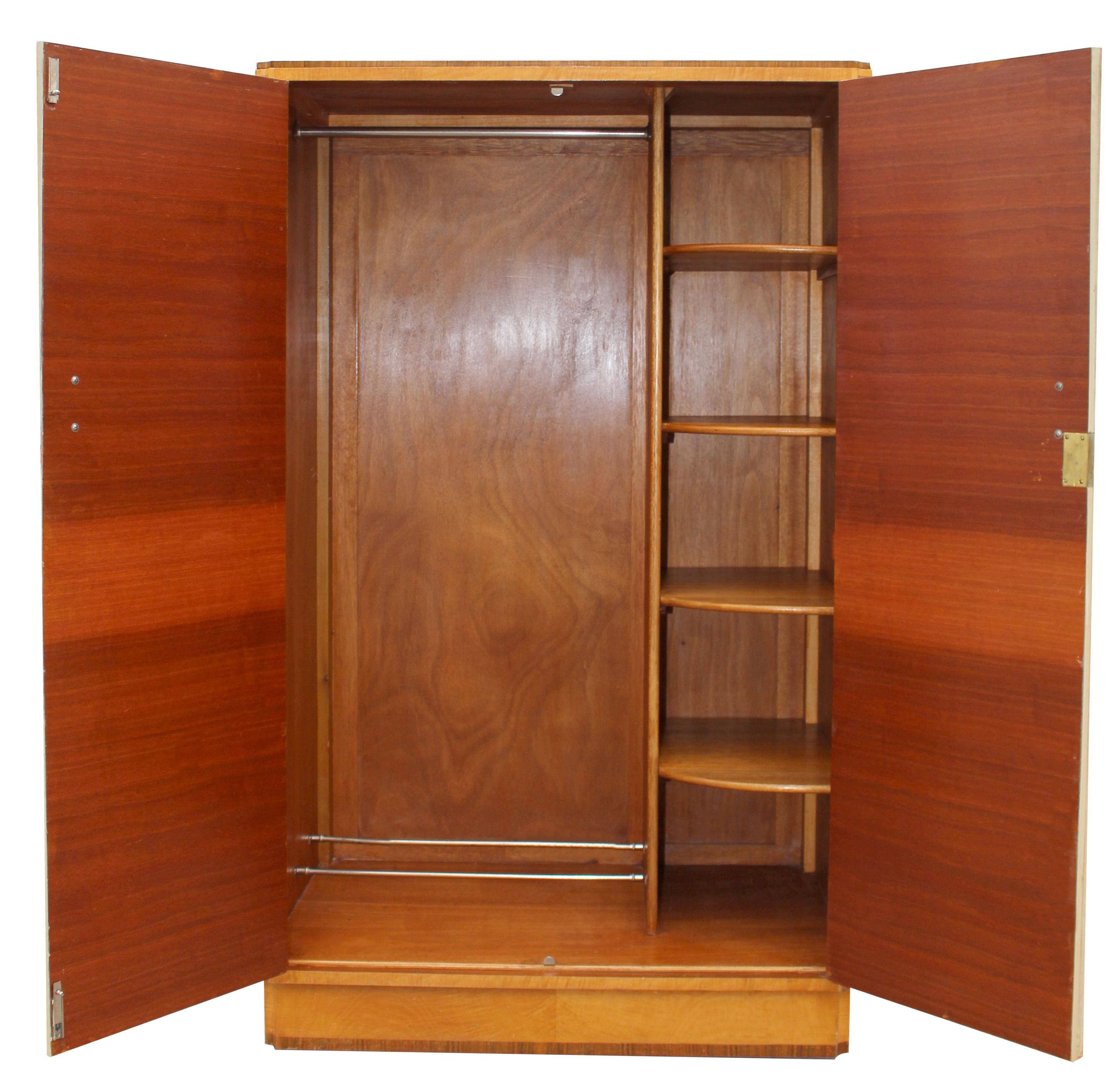 This beautiful wardrobe exudes quality and style. Book paged veneers in a true blonde tiger grain birch with contrasting straight grain walnut veneer banding to the top and base. Lovely detailing to the corners too which are inverted with a scallop