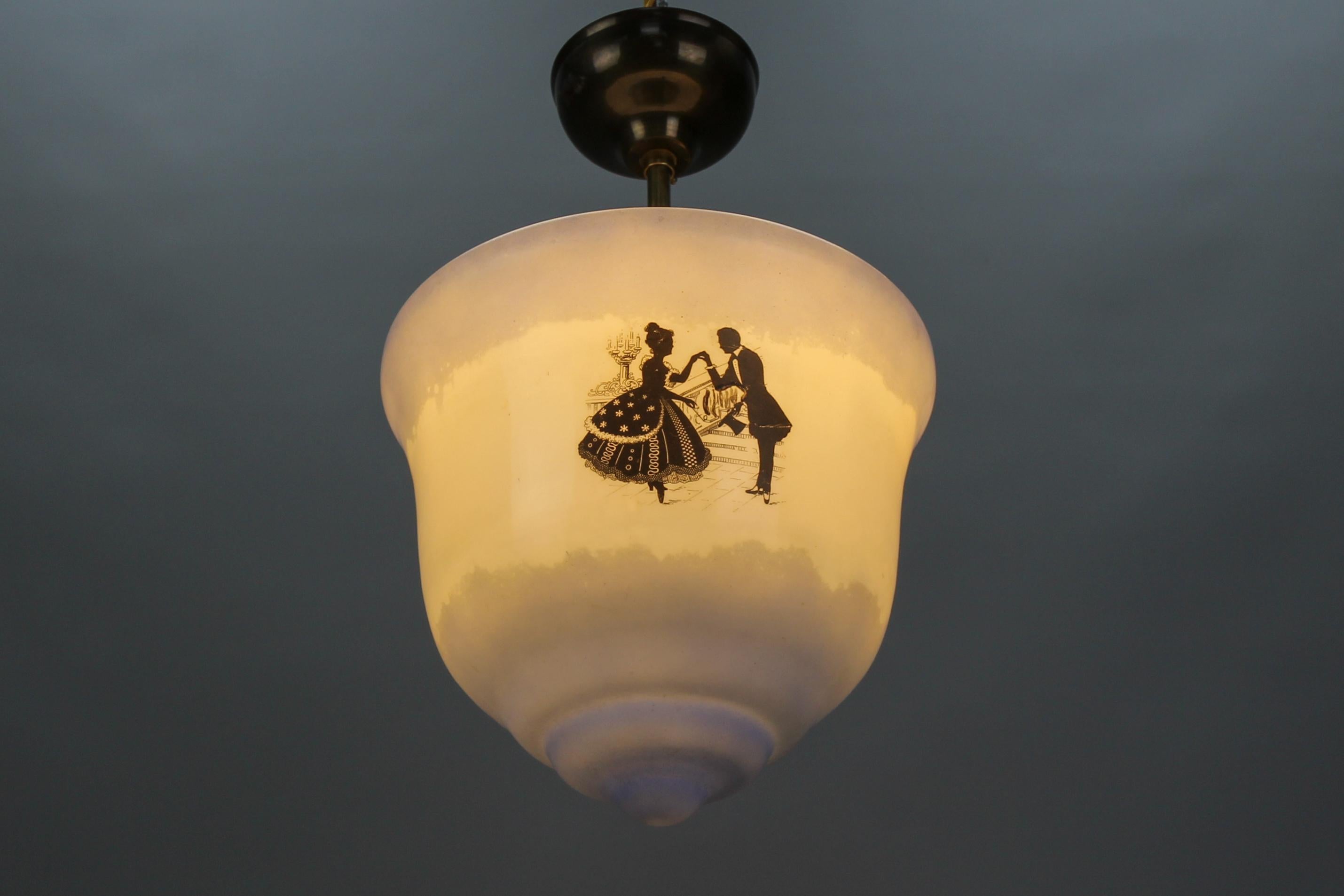 Art Deco blue and white glass pendant ceiling light, Germany, from the 1930s.
An adorable Art Deco period ceiling light from the 1930s. This beautiful single-light pendant features a lantern-shaped glass lampshade in blue and white depicting black