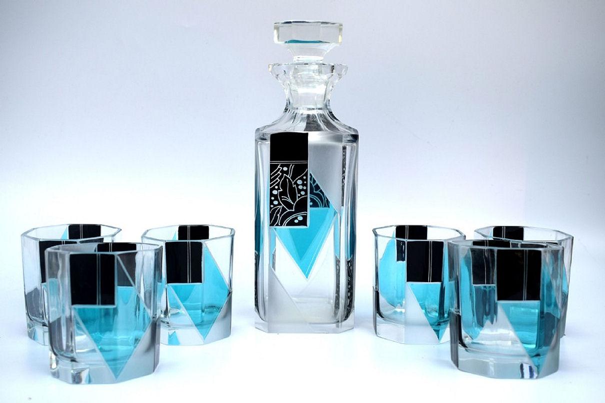 Beautiful Art Deco blue and black decanter set, a wonderful addition to a barware collection. Originating from Czech republic this striking set has a very desirable geometric pattern in a rich blue with black overlay enamel decoration. No chips,