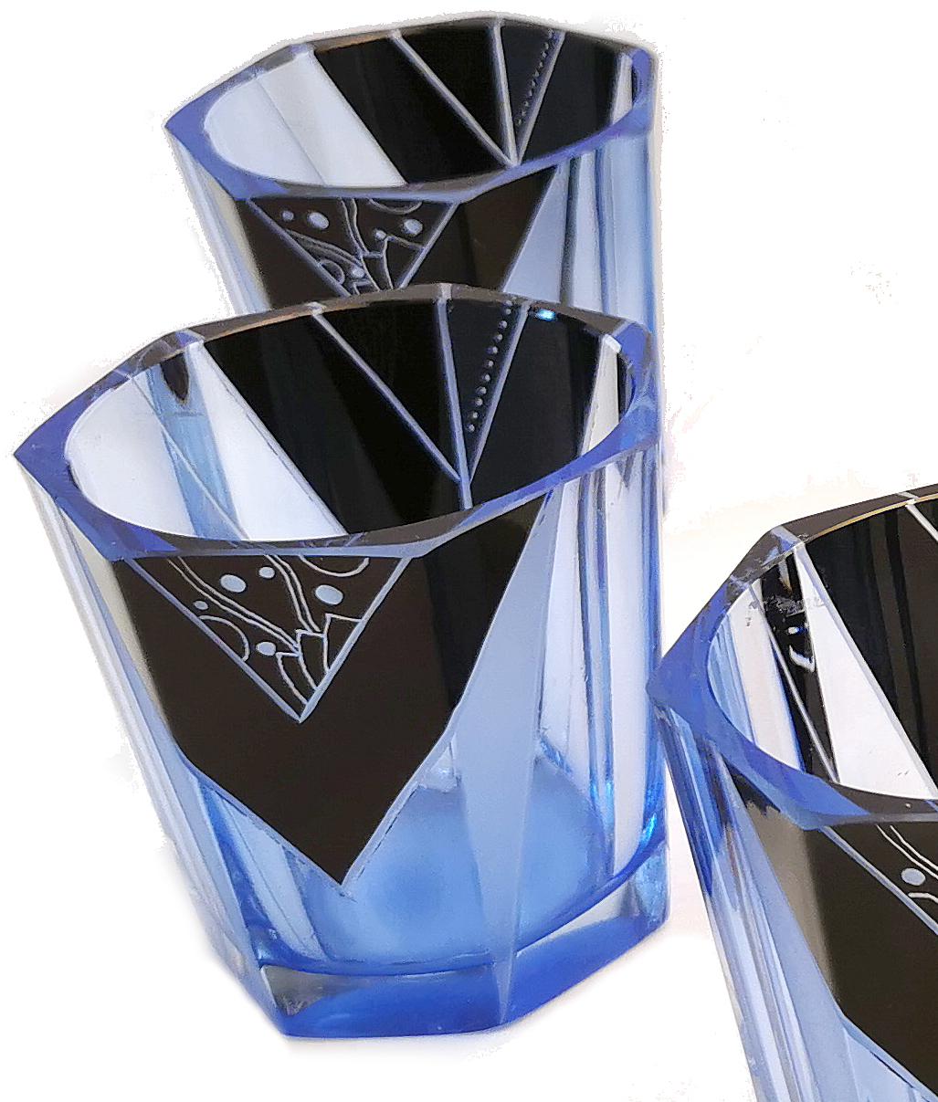 Beautiful Art Deco blue and black decanter set, a wonderful addition to a barware collection. Originating from Czech Republic this striking set has a very desirable geometric pattern with blue glass and black overlay enamel decoration. No chips,