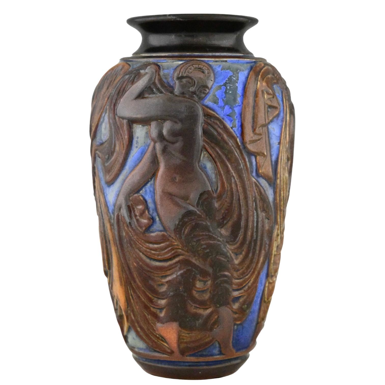Art Deco blue ceramic vase with dancers by Mougin Frères  design by Georges Condé. 
Grès Ceramic with incised decor of dancing nudes on a blue background. 
France 1930.
This vase is illustrated in:
Jacques Peiffer, 
Les frères Mougin, Sorciers du