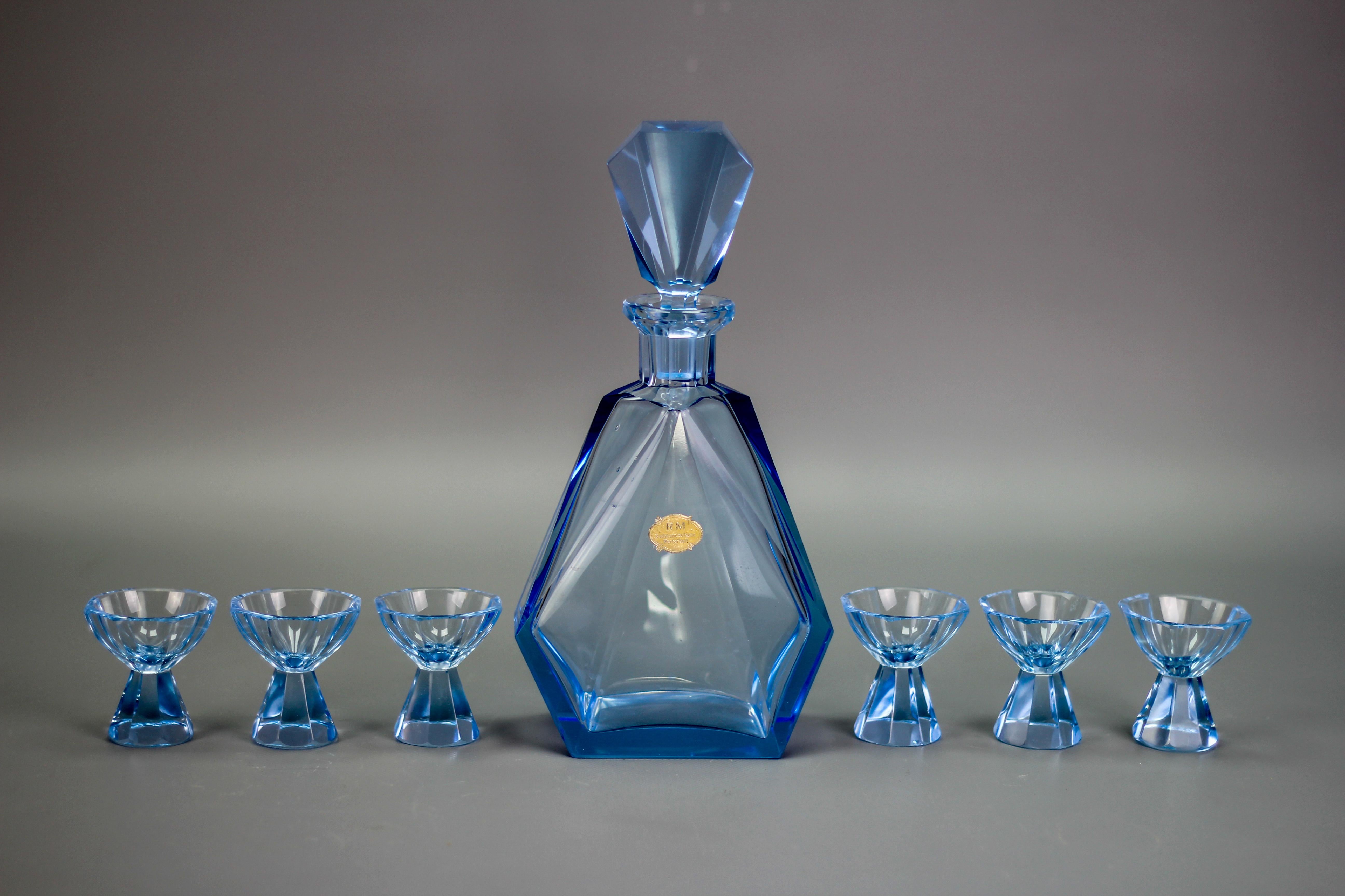 Art Deco blue color Bohemian glass decanter and 6 glasses set, the 1930s
Beautifully colored, handmade Czech Bohemian glass set - decanter and six matching glasses, made in the 1930s. The set is in a very nice light blue color. Label on the