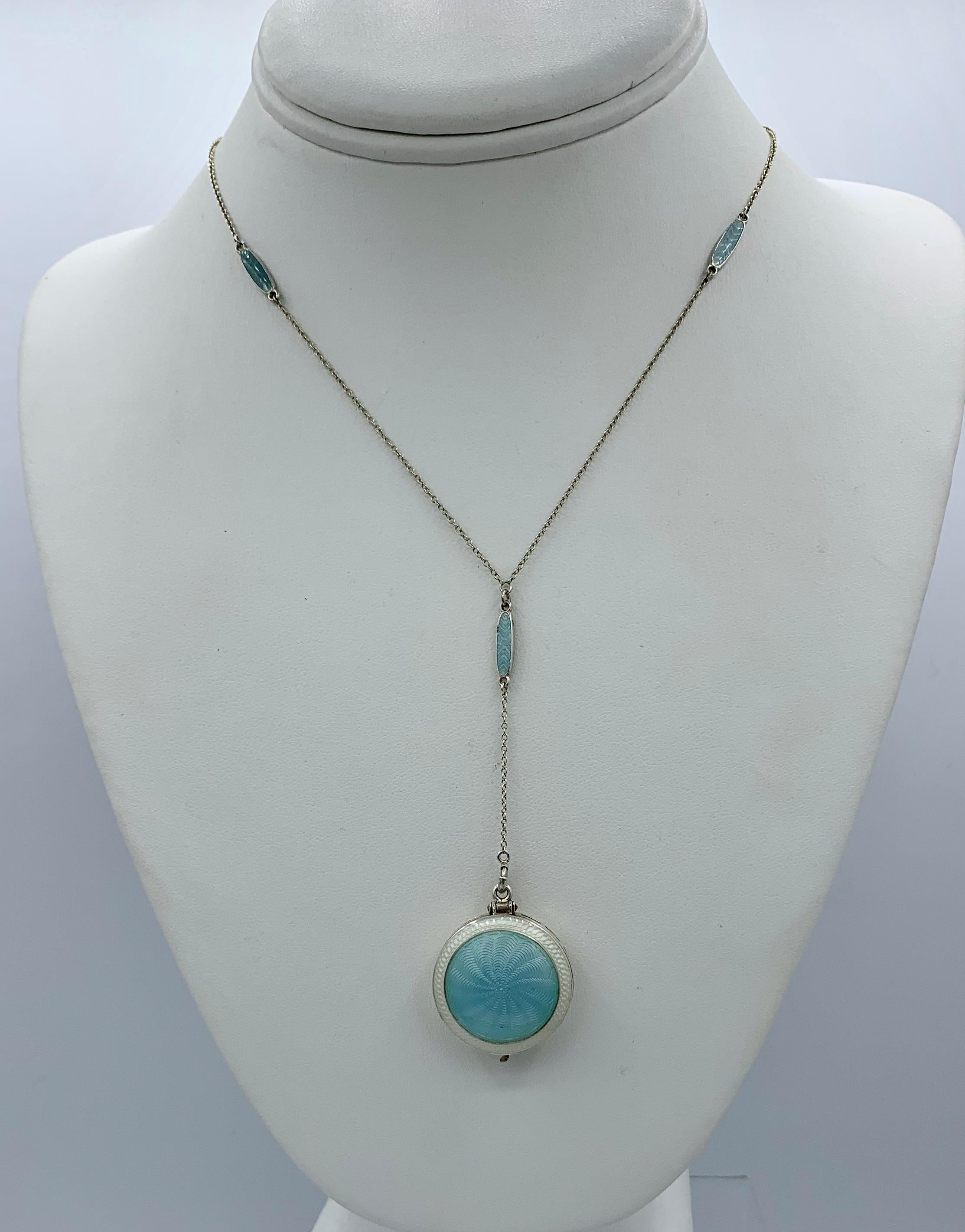 A rare and wonderful Edwardian - Art Deco Locket Pendant Necklace with gorgeous Robin's Egg Blue and White Guilloche Enamel in a pale blue blue color over Sterling Silver.  The reverse of the locket is engraved with the date 1917 and initials which