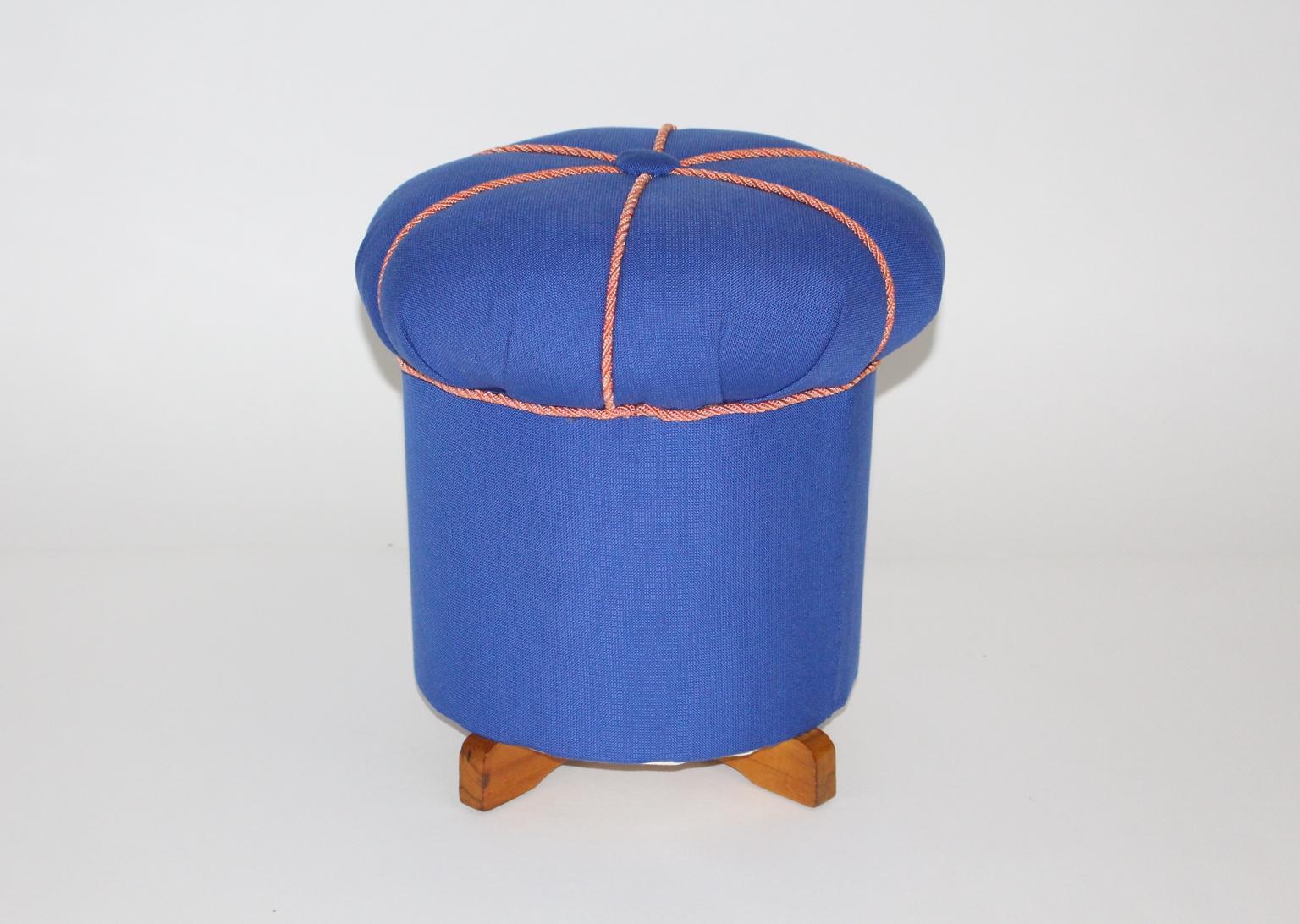 The presented vintage pouf features beech wood feet and was recently covered with electric blue textile fabric and pink cords.
The pouf was designed and made in Austria, circa 1930.
Also the vintage condition is very good.
Approximate