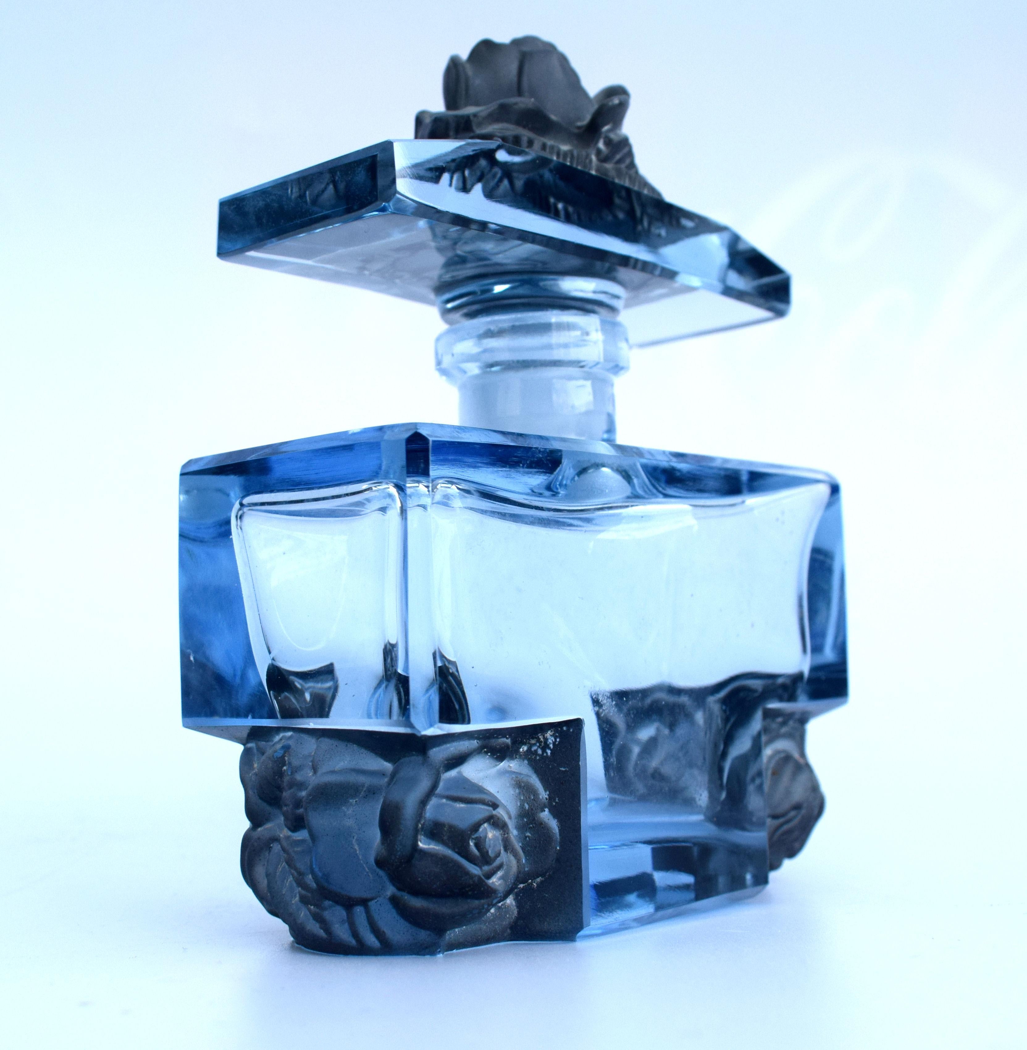 A truly beautiful blue glass 1930s ladies perfume bottle decorated with moulded floral brackets as floral friezes in which also serve as feet the recessed box shape. Most likely this piece is made by the Czech glass maker Josef Hofmann, very