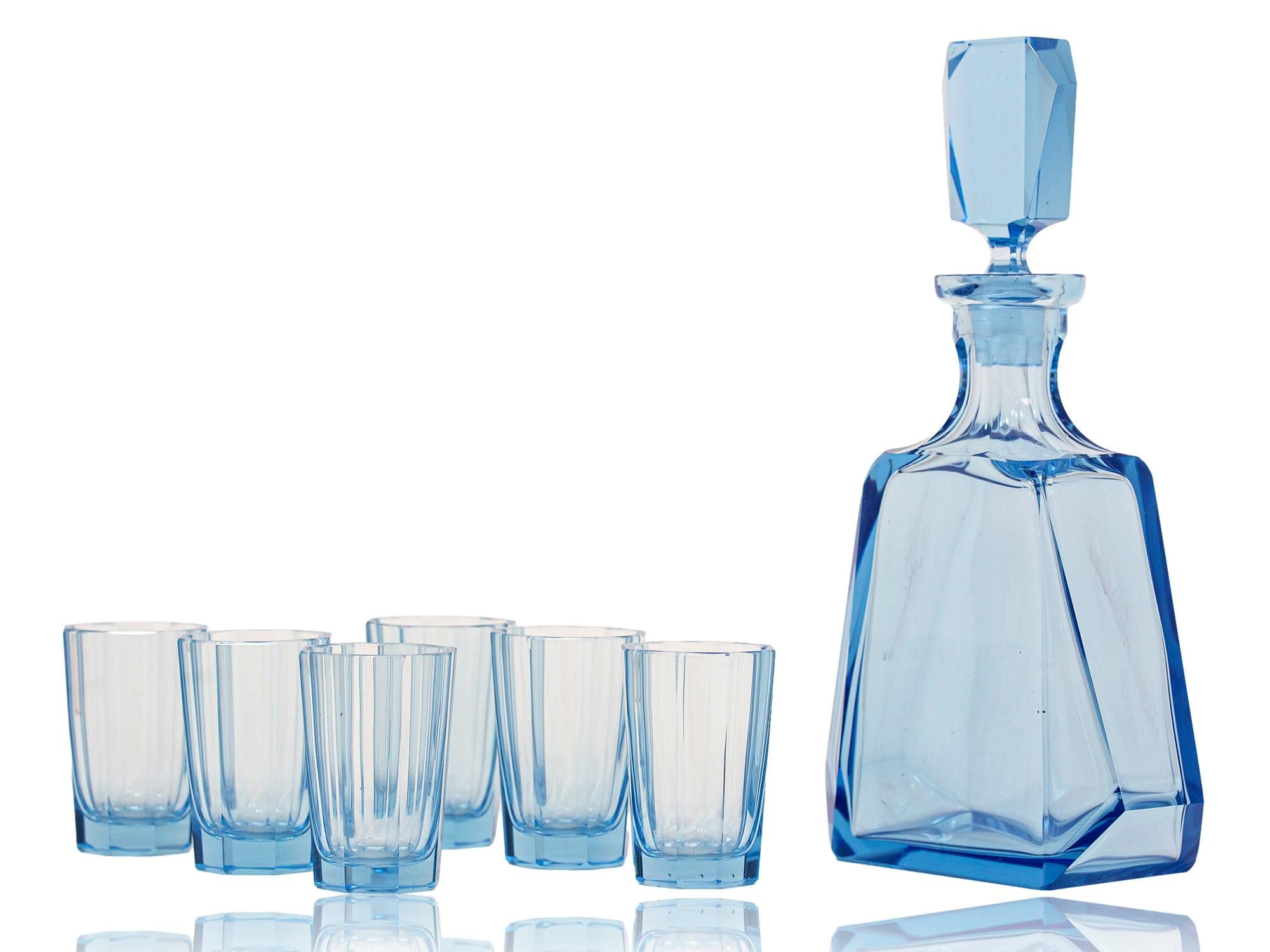 Complete with six shot Glasses

From our Barware collection, we are delighted to offer this Art Deco Decanter Set. The set is beautifully formed with a vibrant blue base colour having faceted sides to all pieces. The Decanter of abstract pyramid