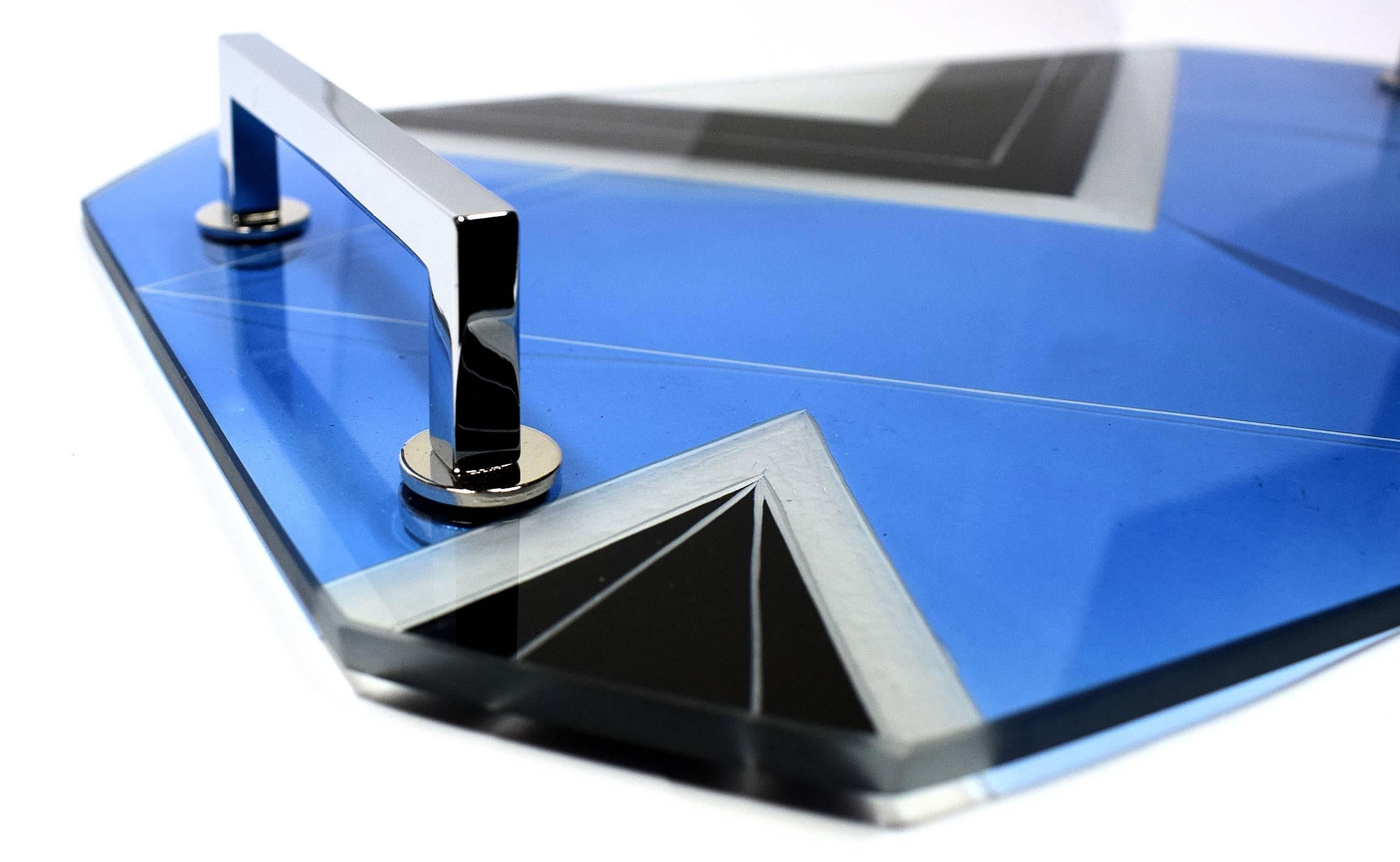 What a great find! This Art Deco tray is made from thick glass with enamel and etched glass geometric design. Very striking and in fabulous condition. There are two chrome bar handles; the chrome is also very good, free from any pitting. Ideal for