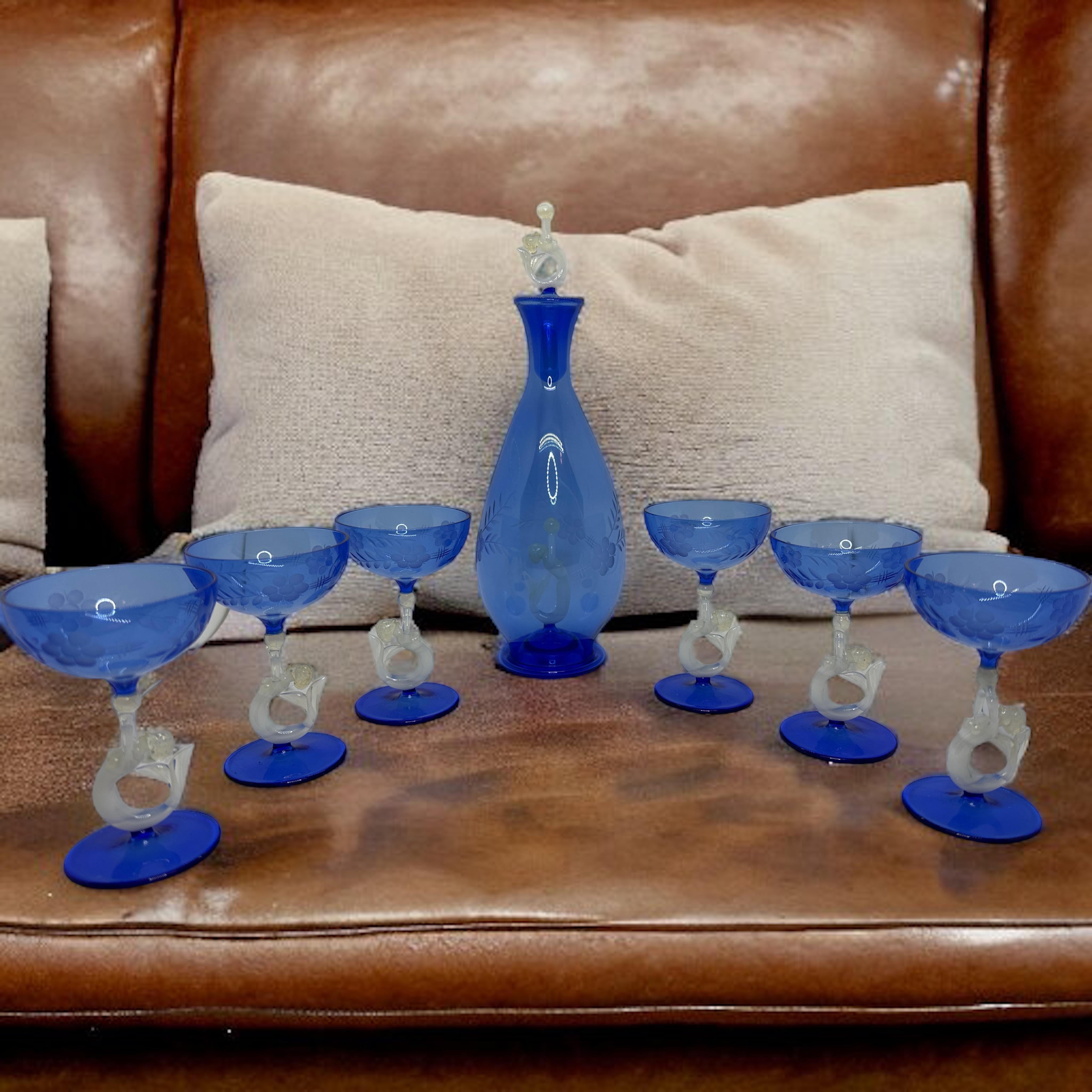 
A slightly cheeky Art Deco decanter set with matching set of six glasses in handblown blue glass, in the style of Bimini. The stems designed as nude mermaid. Very delicate to touch and amazing that something like this last all these years. This