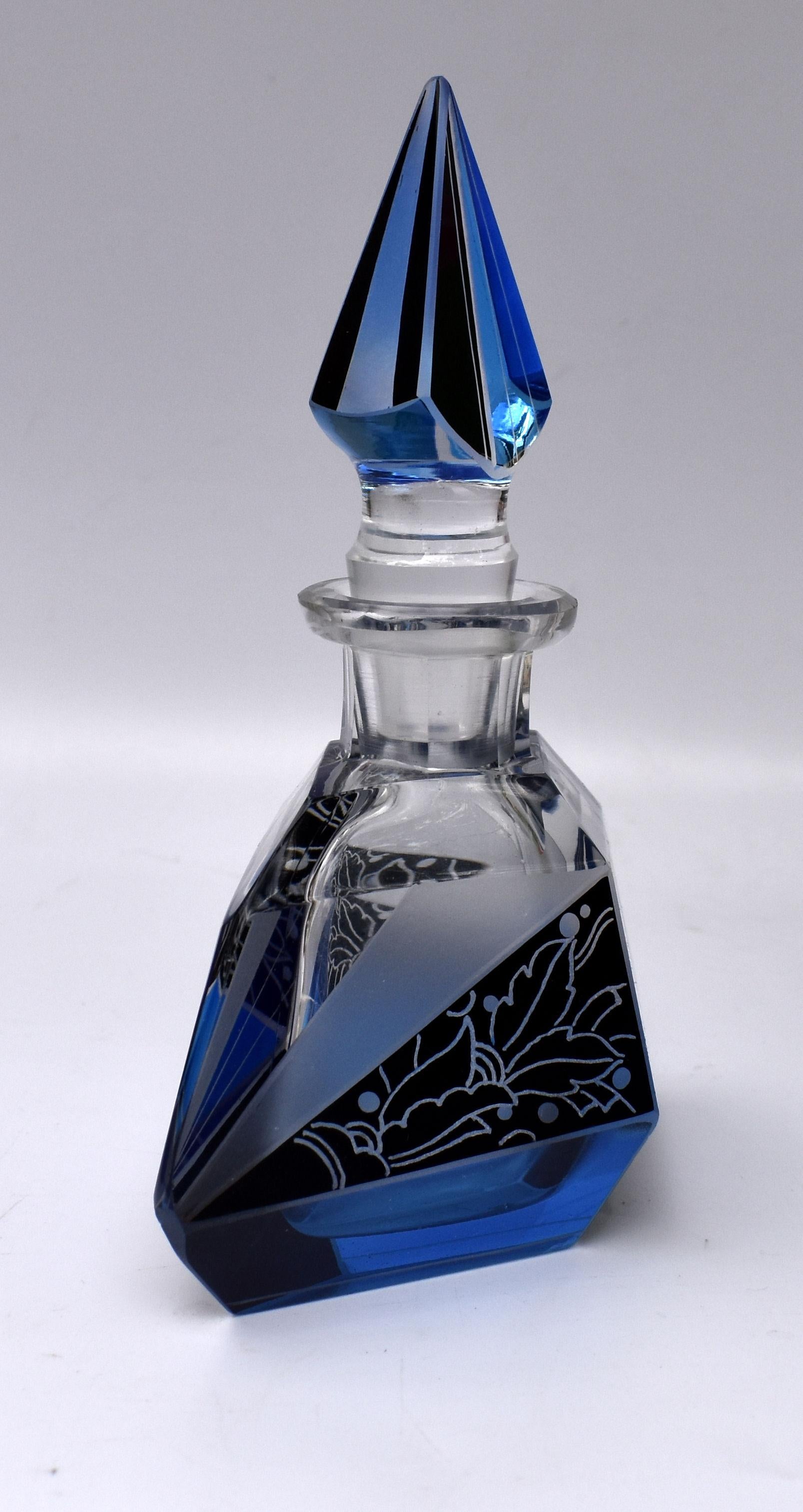 A truly beautiful Art Deco perfume bottle with a very attractive and iconic shape and patterning with geometric black enamel decoration to both the body of the bottle and stopper. Manufactured in Czech republic in the 1930s this stunning bottle is