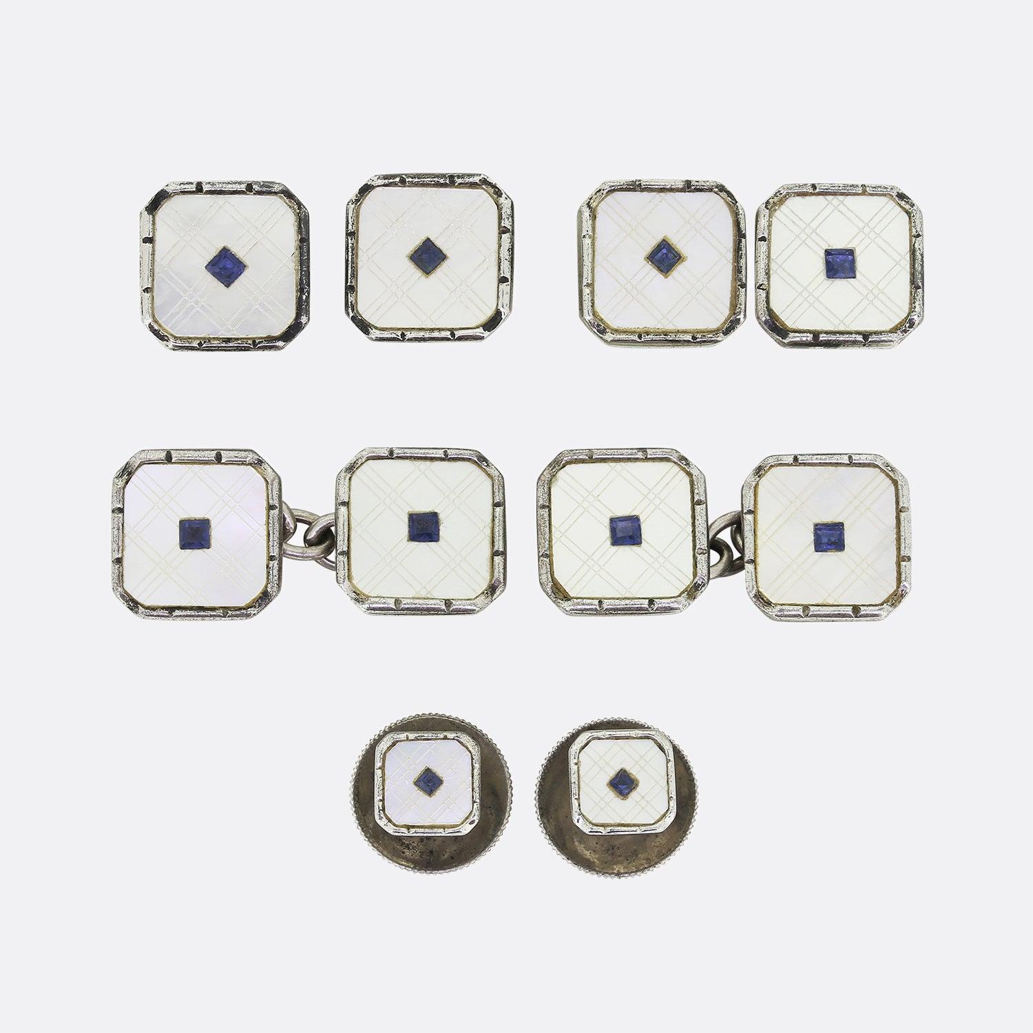 This is an exquisite original Art Deco 1930s sterling silver boxed set of cufflinks, collar studs and buttons with clip rings in an original fitted shark skin box. Each square shaped piece features a square cut blue paste stone at the centre of a
