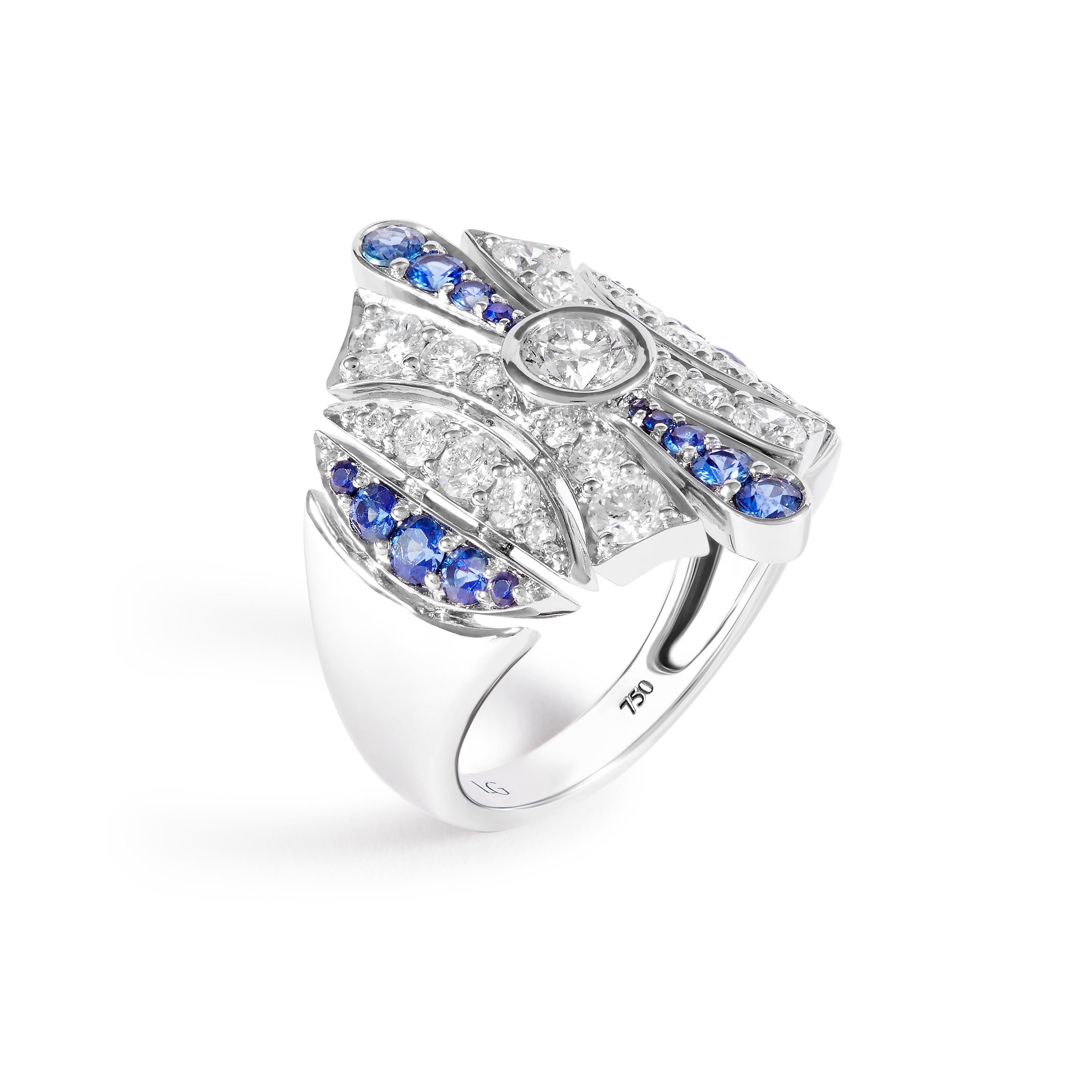 Art Deco ring featuring 0.69 carat of Blue Sapphires and 1.41 carats of Diamonds set in 18K White Gold. A round brilliant diamond is bezel-set in the center and there is some space between each of the ring's sections, typical of the Art Deco style