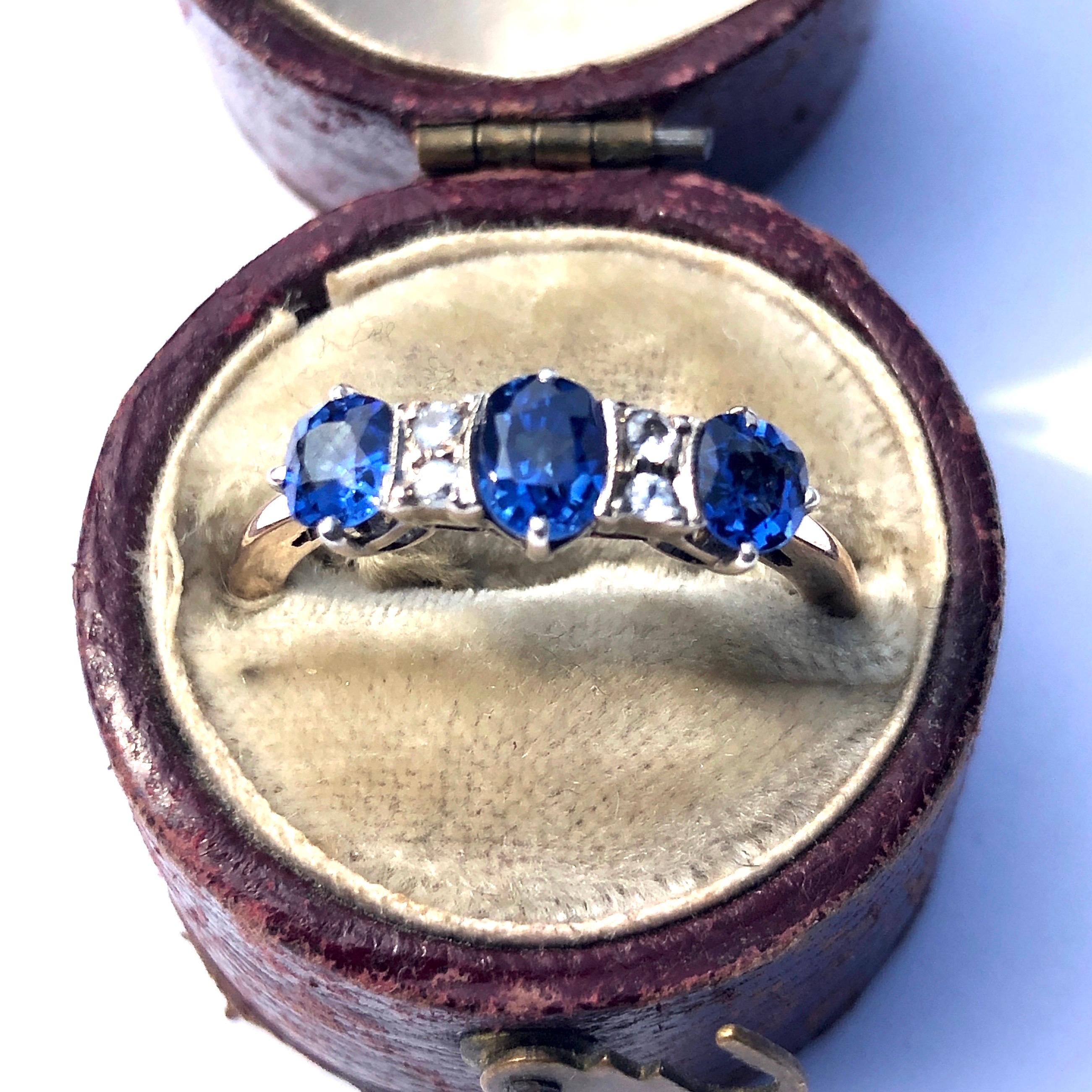 The sapphires in this ring are an eye-catching bight blue colour with a wonderful shimmer them. The total to approximately 1ct and the central stone has two pairs of white sapphires either side. The 9ct gold setting is very subtle which lets the