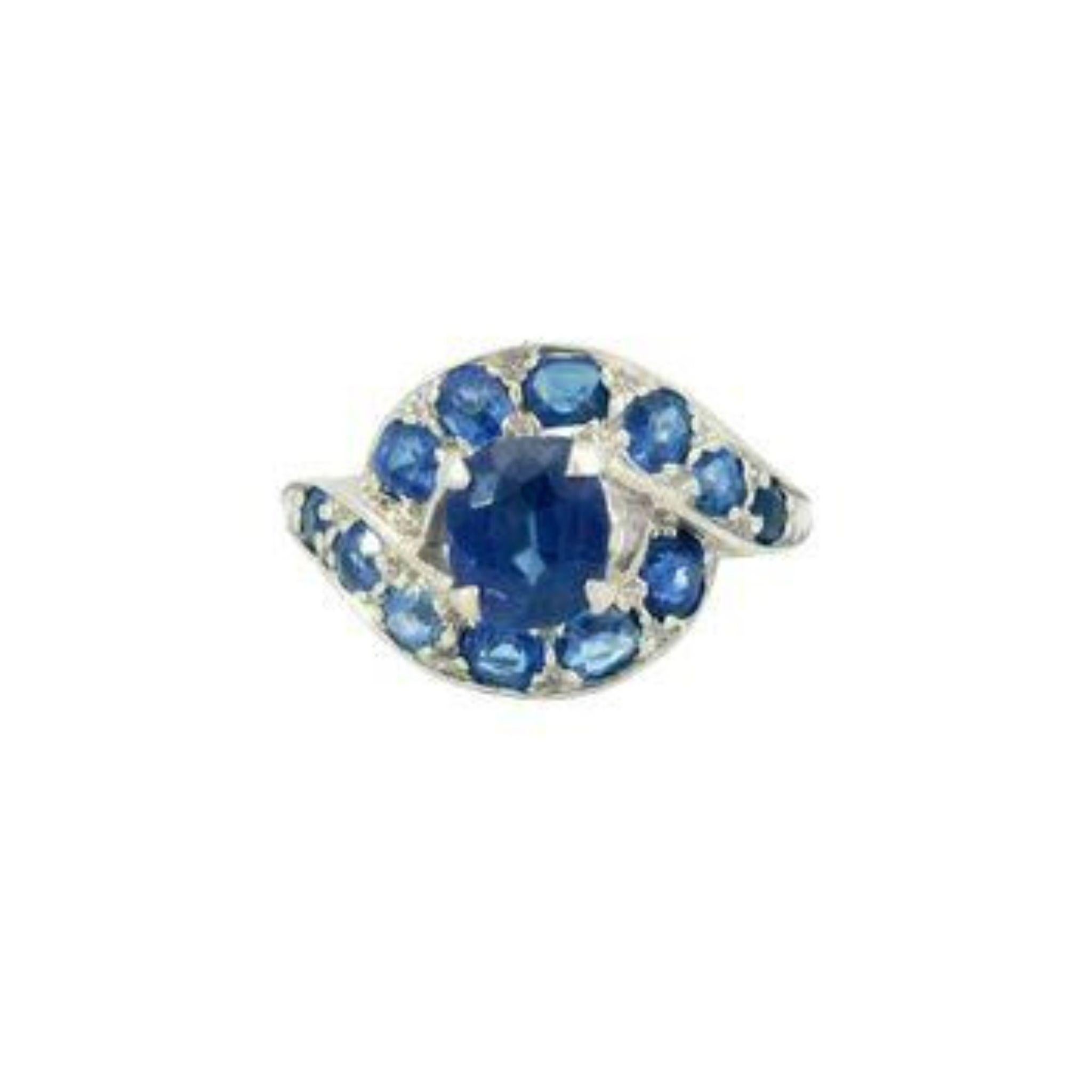 Art Deco No Heat Sapphire Bypass Halo Ring 14K White Gold

A dance of color and elegance comes to life in this remarkable Art Deco ring, crafted in 1920. At its heart lies a stunning 1.00-carat oval-cut blue sapphire, its deep, vivid hue drawing you