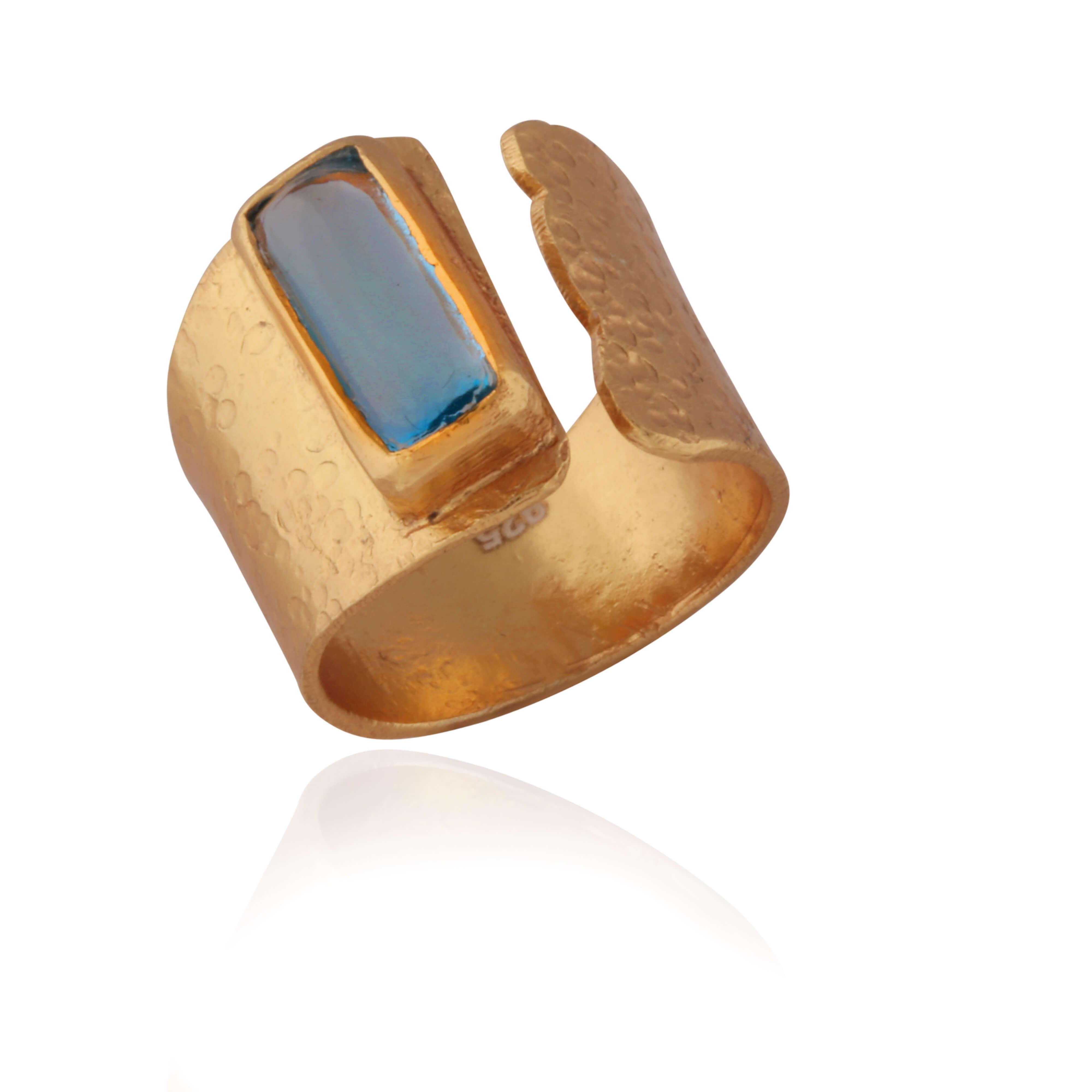 A beautiful art deco, on trend ring set with a striking blue topaz stone.

Has room for adjustment so the ring can fit various fingers.

Gold plated on silver.

UK Size: N, 17mm.