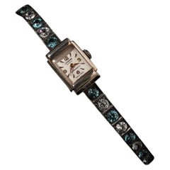 Montre-bracelet de style Art déco, type « tennis », avec zircons bleus et blancs, en or blanc 9 carats et argent