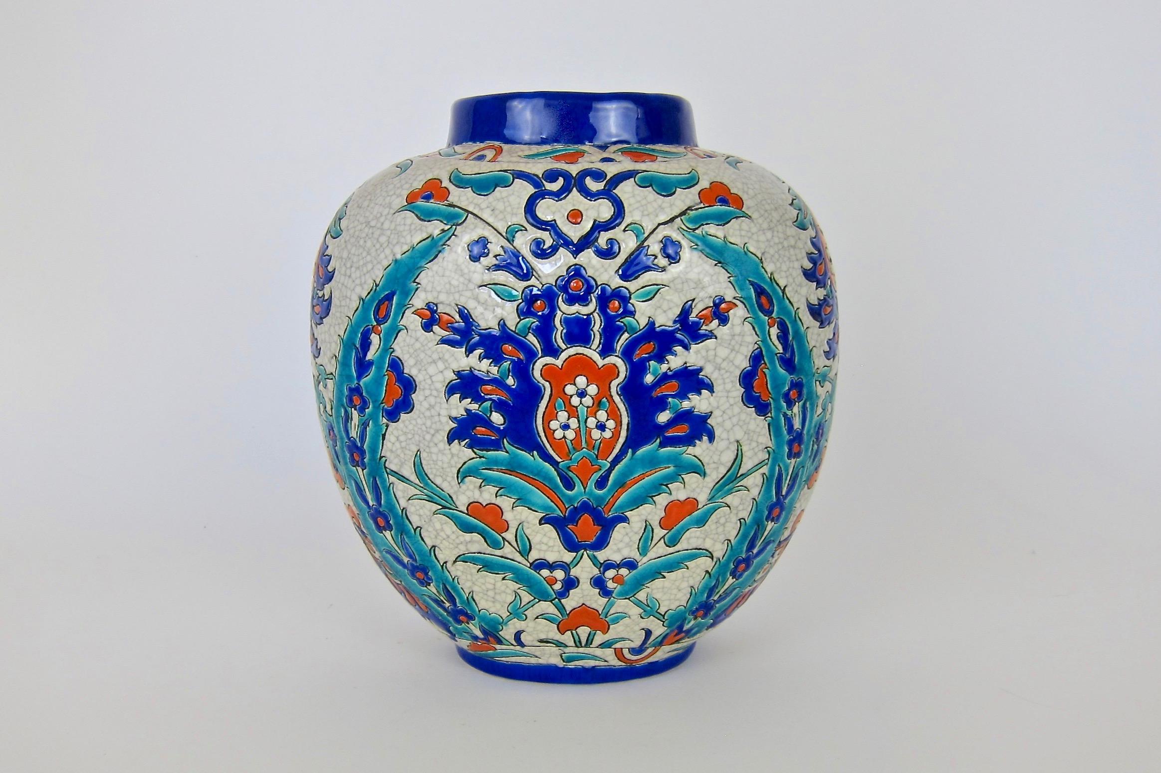 A Boch Freres Keramis art pottery vase designed by Raymond Chevallier (1900-1959)  in the company's Persian decor produced at La Louvière, Belgium during the late Art Deco period, circa 1940. 

The Boch Freres studio led by Chevallier's colleague