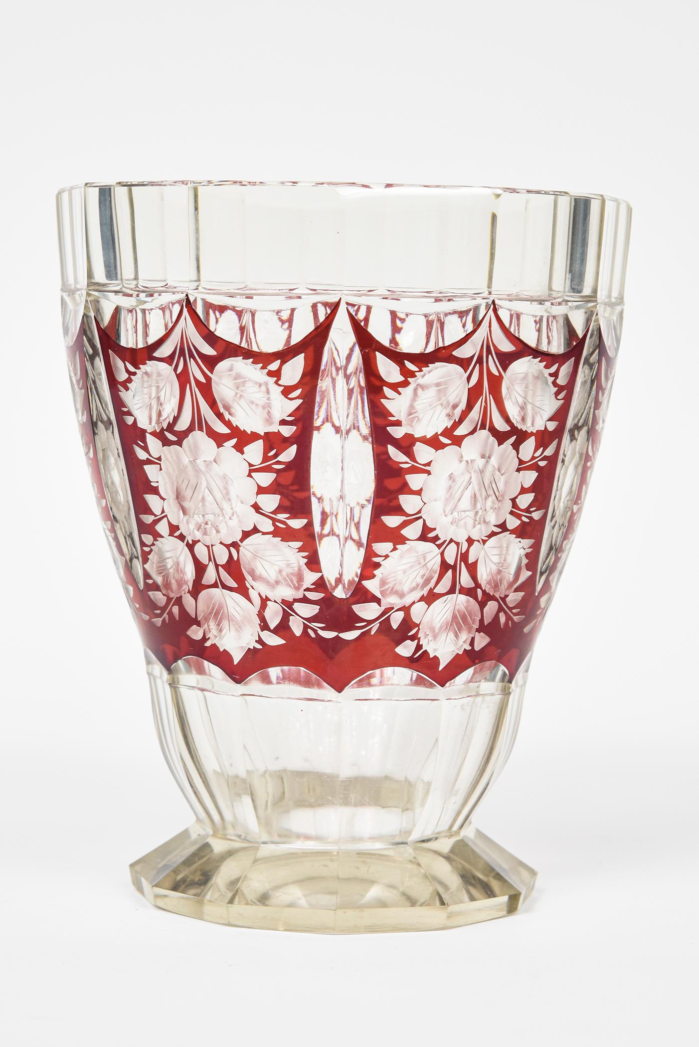 1930s Czech Art Deco cranberry red enamel and clear glass vase featuring a geometric shaped flaring body vase with a 12 sided foot base. The vase has 6 flower and leaf sections.