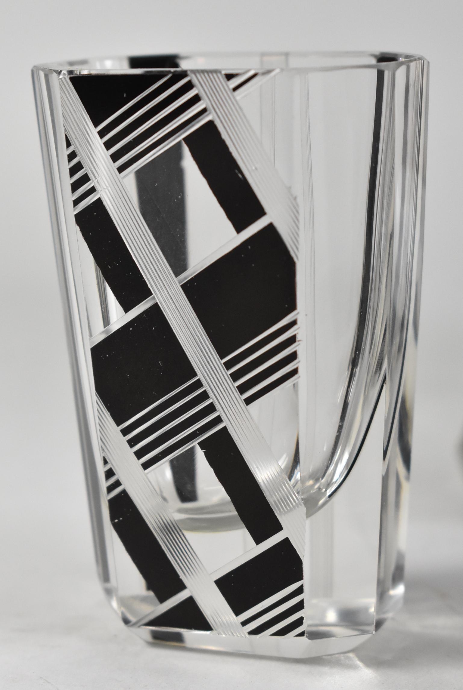 Art Deco decanter and four shot glasses attributed to Karl Palda. This decanter set is hand decorated in the iconic Karl Palda style with bold black enamel work. The geometric design reflects the style and symmetry that define the Art Deco period.