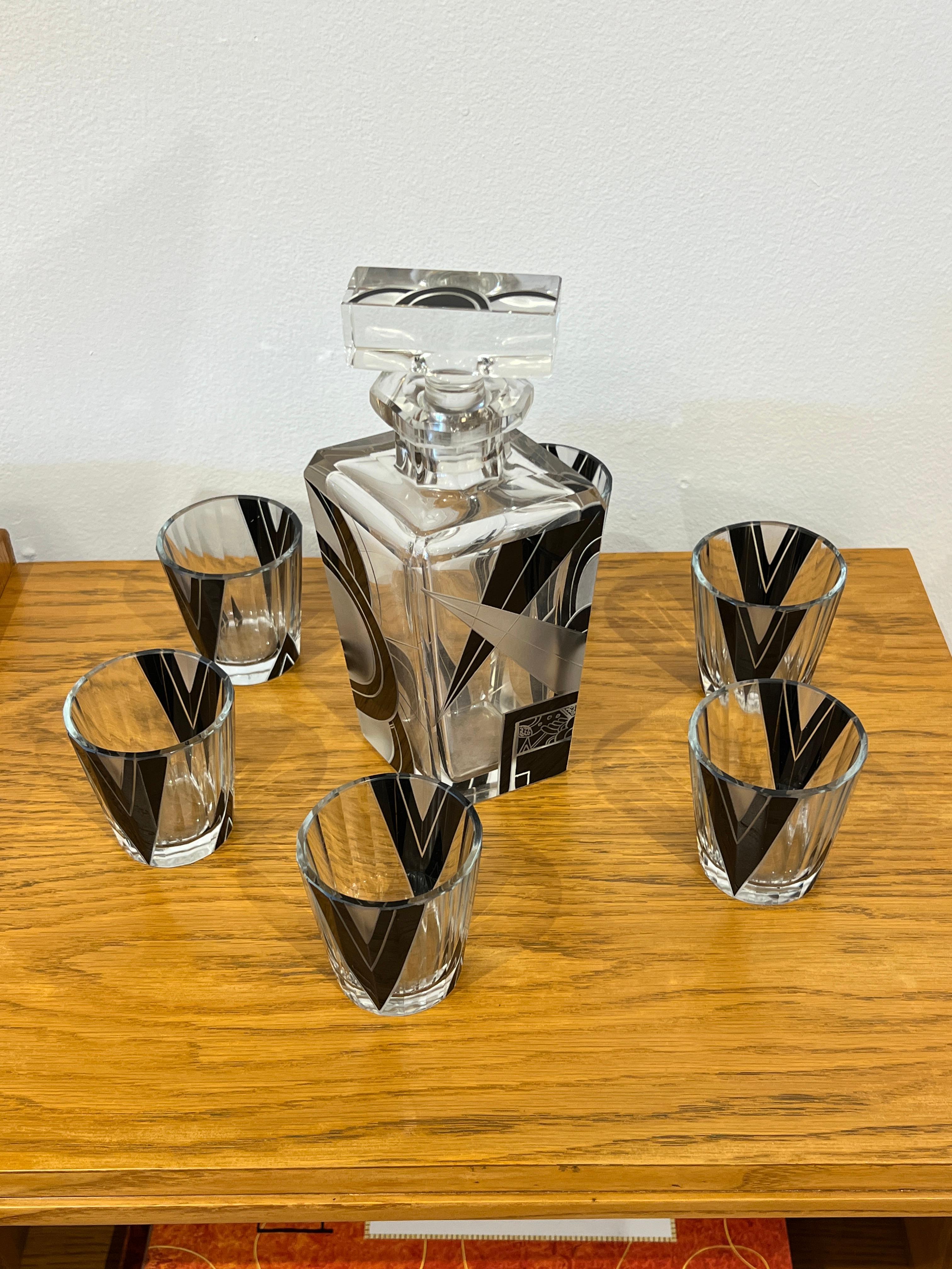 A gorgeous Bohemian Glass with black enamel details decanter set that includes 6 shot glasses.