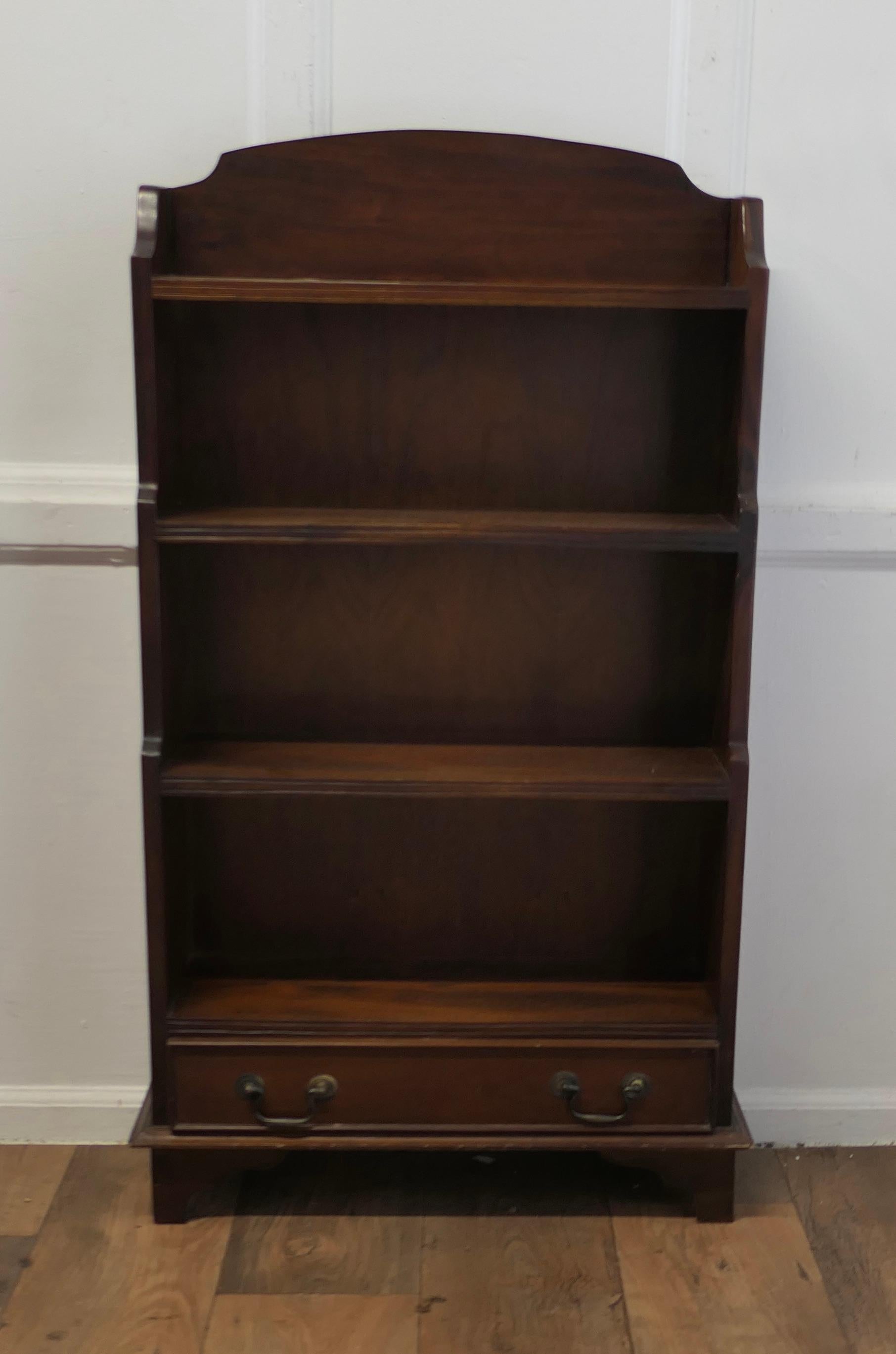 Art Deco Book Case with a Drawer at the Bottom

This charming little shelf unit has a gallery to the back and a waterfall shape to the sides, it has 4 open shelves, and at the bottom there is a long drawer
The shelf is in good condition and is an