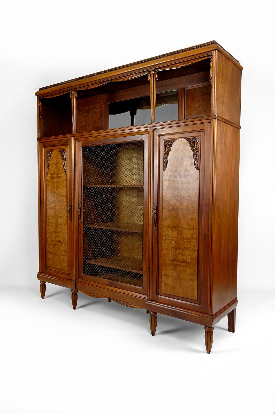 Beveled Art Deco bookcase / cabinet / display case in carved walnut, France, circa 1925 For Sale