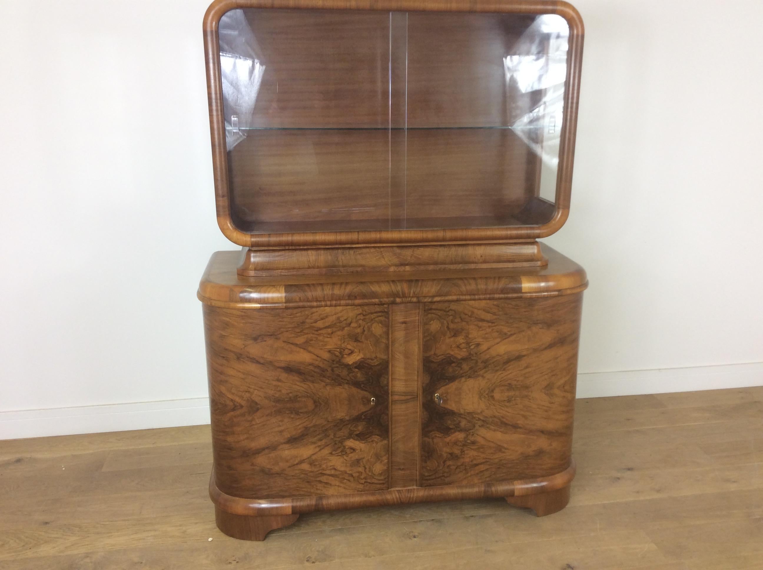 Art Deco Display cabinet by Jindrich Halabala
presented in a beautiful figured walnut, well crafted with curved edges.
166 cm H 127 cm W 52 cm D
Czech, circa 1930.