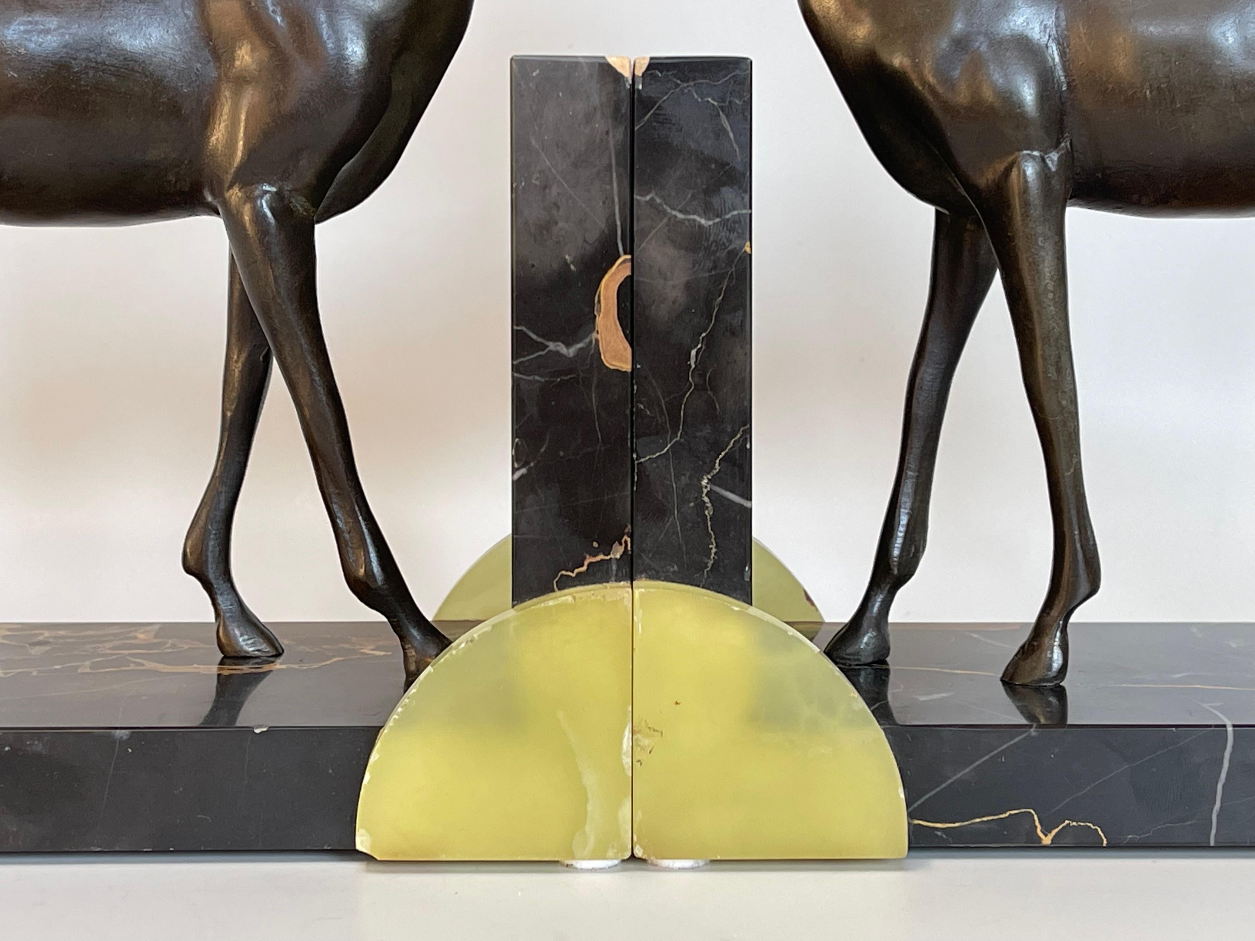 Large pair of spelter bookends around 1930 by Jacques Limousin.
Antelope on a portor marble base and onyx application.
Signed Limousin on the base.
In very good state of conservation.
Small chips on the onyx are to be noted.
Length: