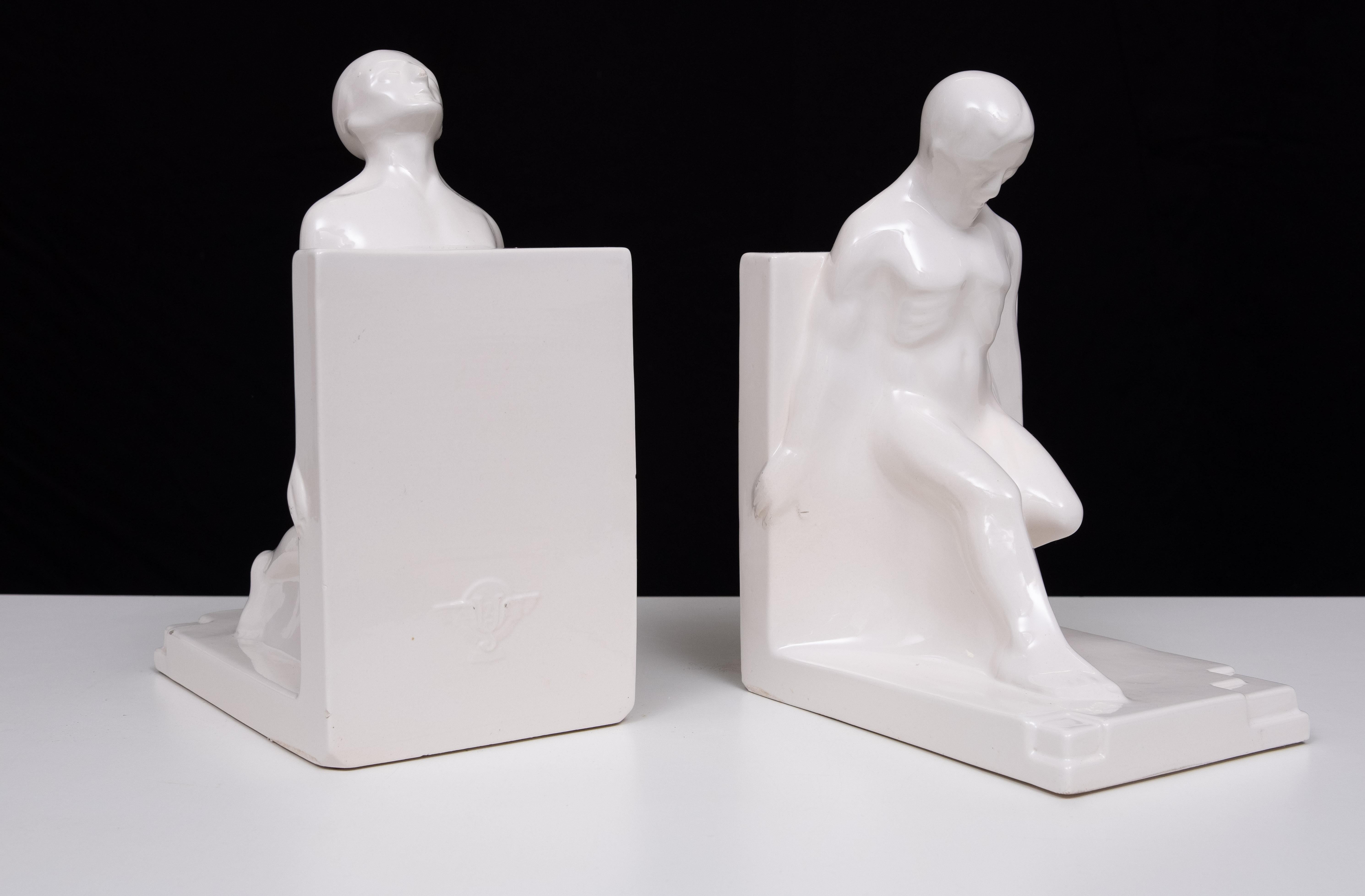 1930s Large Art Deco Bookends of Nude Muscular Man. These were designed by Godefridus Boonekamp in the 1920s and made in the Netherlands by Plateelbakkerij Schoonhoven circa 1930s. This set of white bookends are made of white glazed ceramic.
some