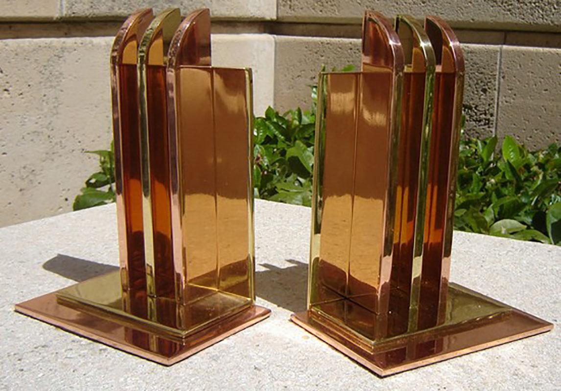 Pair of streamline Art Deco bookends designed by Walter Von Nessen for the Chase Brass Company. The bookends feature a stepped base with a copper, brass, and bronze construction. Walter Von Nessen (- 1943) designed for the Chase Brass and Copper