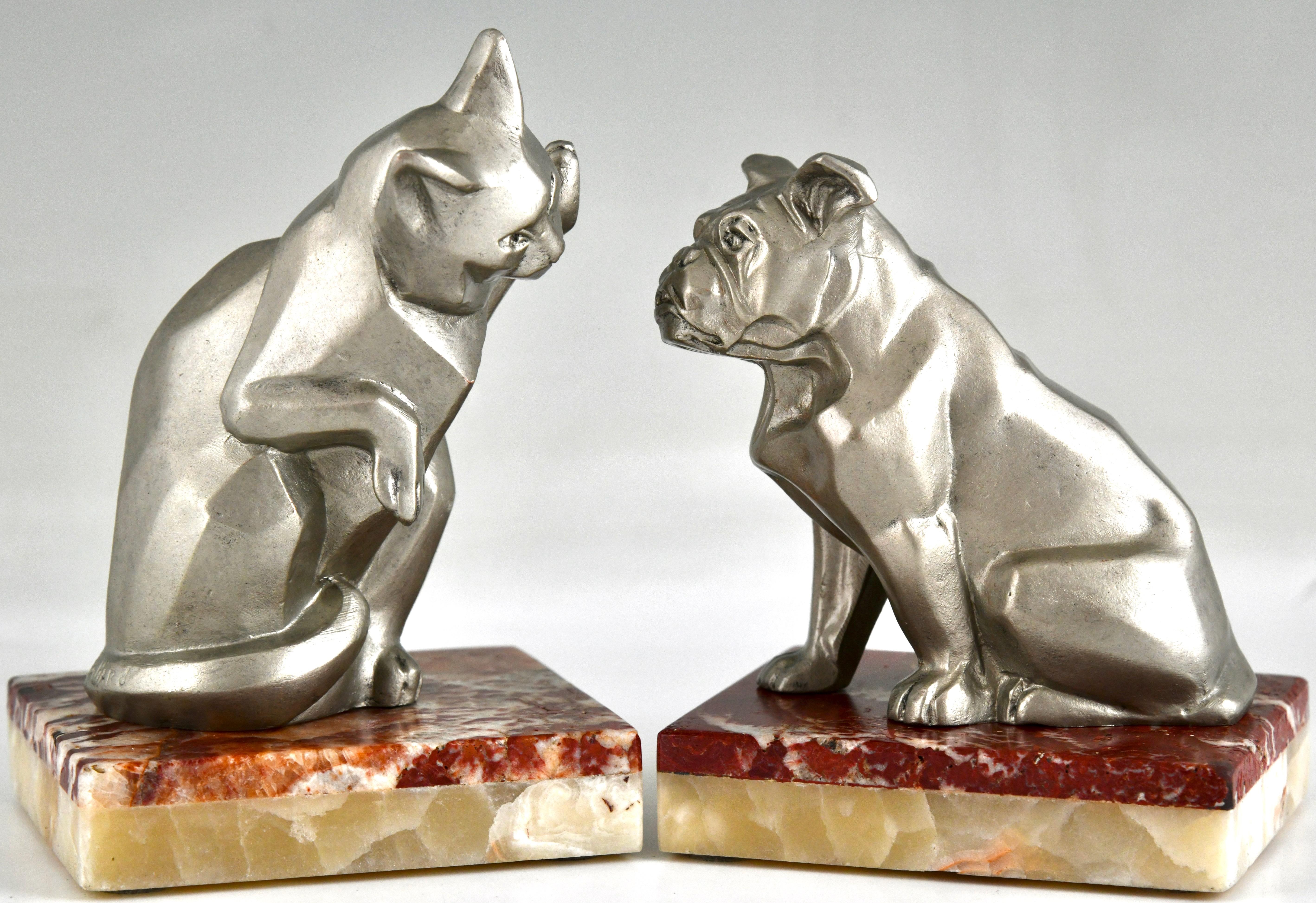 Art Deco bookends cat and bulldog signed by Irenée Rochard. 
Art Metal with silver patina on a marble and onyx base. France 1930. 
Animals in bronze by Christopher Payne. Antique collectors club. 
Literature:
Dictionnaire des peintres,