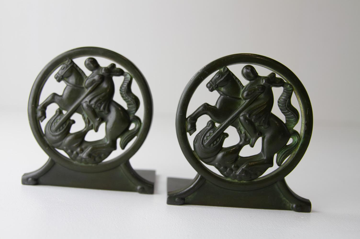 Art Deco Bookends in Disko Metal by Just Andersen, 1930s. Set of 2.
Wonderful pair of book ends designed by Danish sculptor Just Andersen in Denmark in the 1930s. 
Depicting Saint George slaying the dragon. Made of Disko Metal which is an alloy