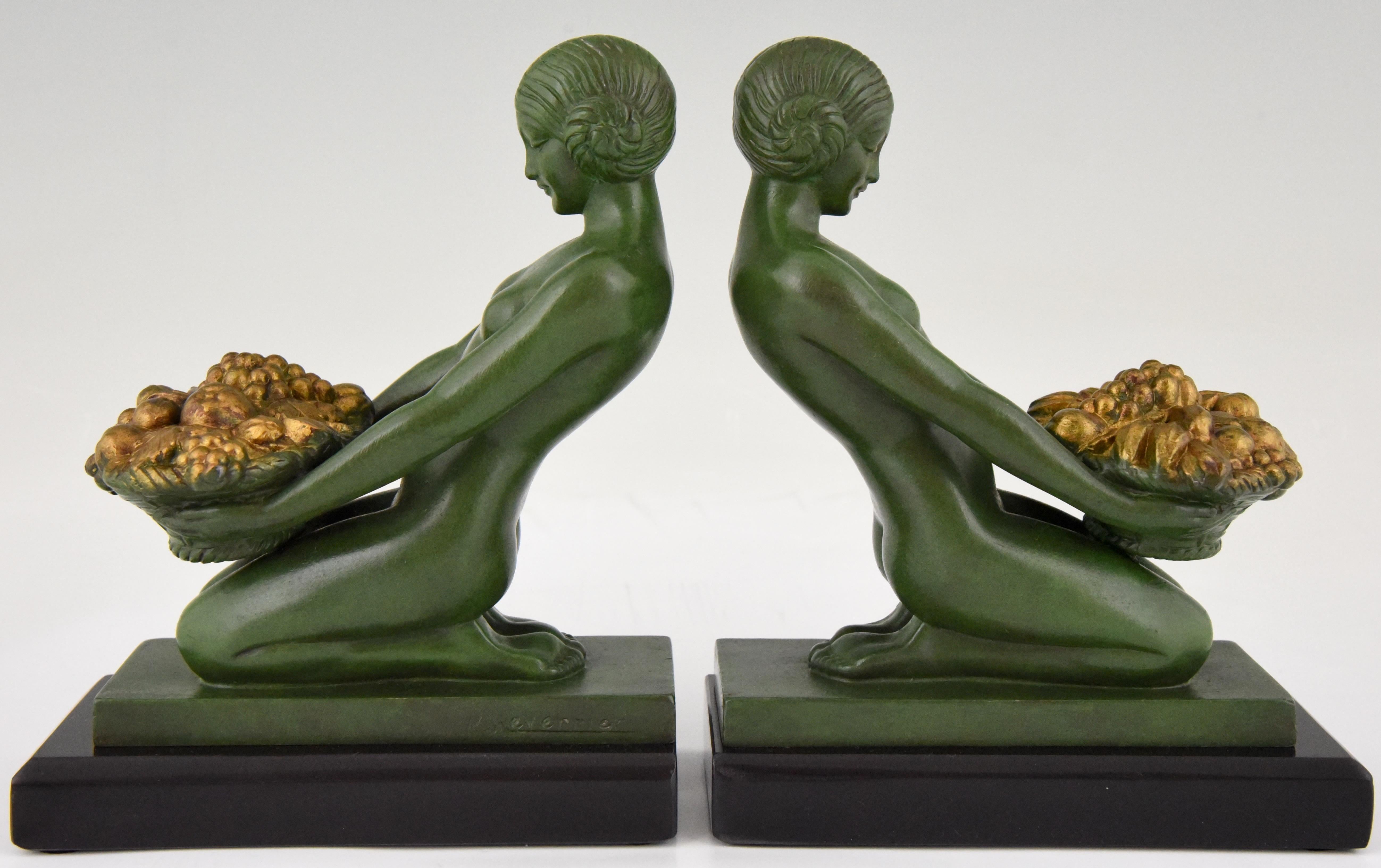 Art Deco bookends with kneeling nudes holding baskets by the famous French sculptor Max Le Verrier. Patinated Art Metal on a fine Belgian Black marble base. France 1930

“Statuettes of the Art Deco period’ Alberto Shayo. ?“Art deco sculpture” by