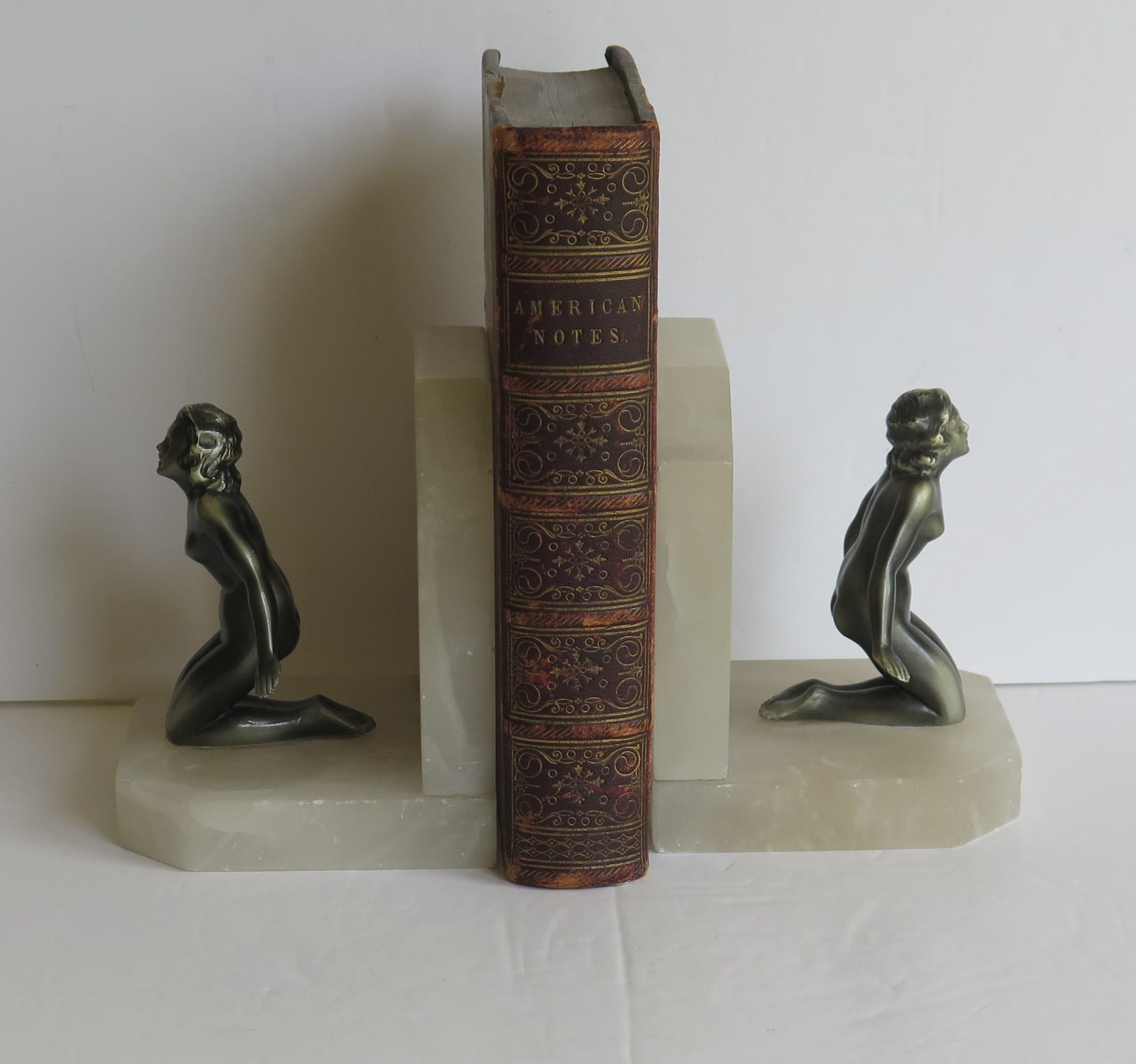 These are a beautiful pair of French, Art Deco period, book ends of two metal lady figures on stone bases.

Each Lady has been well modelled in a typical Art Deco kneeling pose, with good detail and colour. They are made of metal having a bronzed