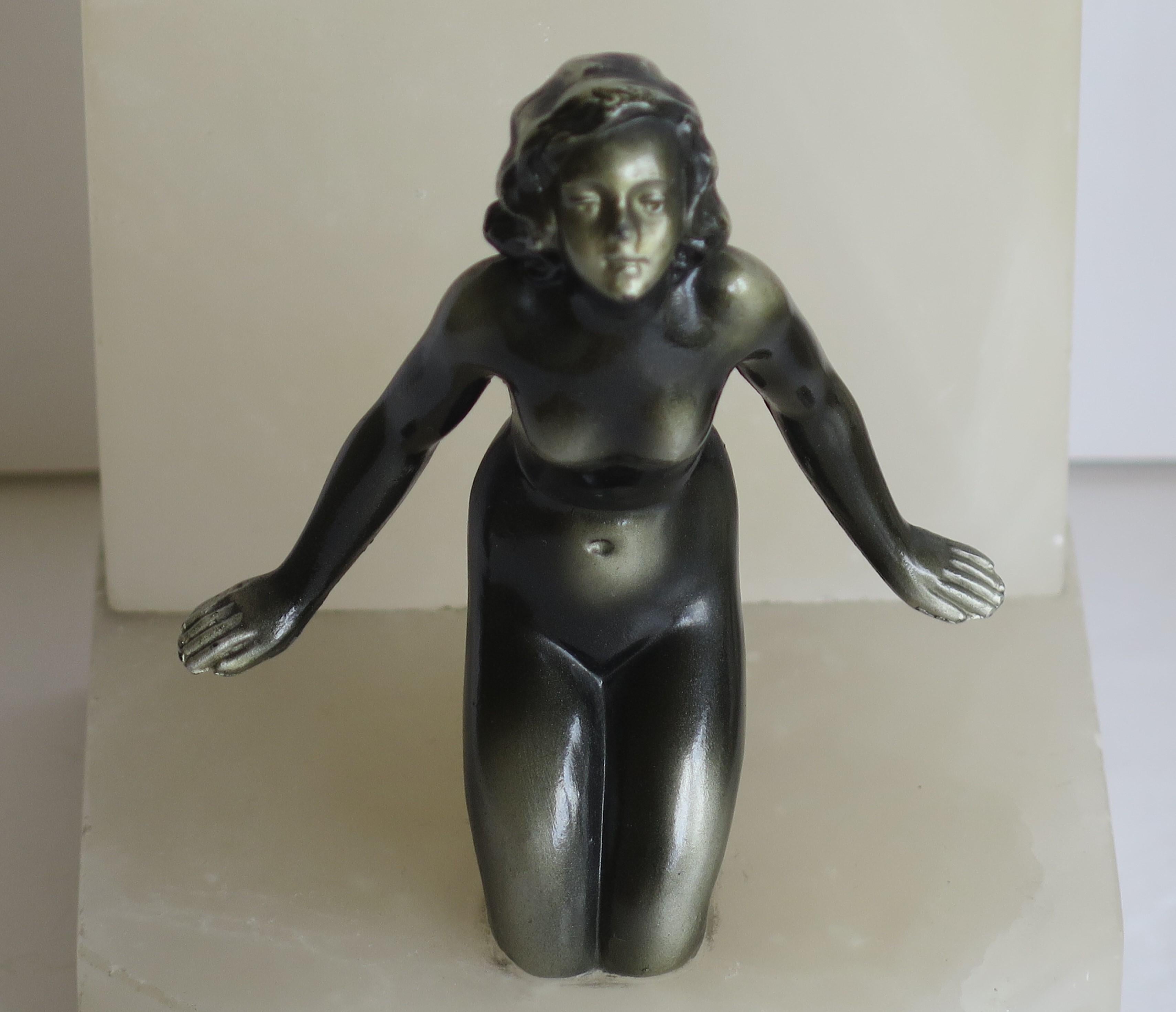 Polished Art Deco Bookends Metal Lady Figures on Stone Bases, French, circa 1930