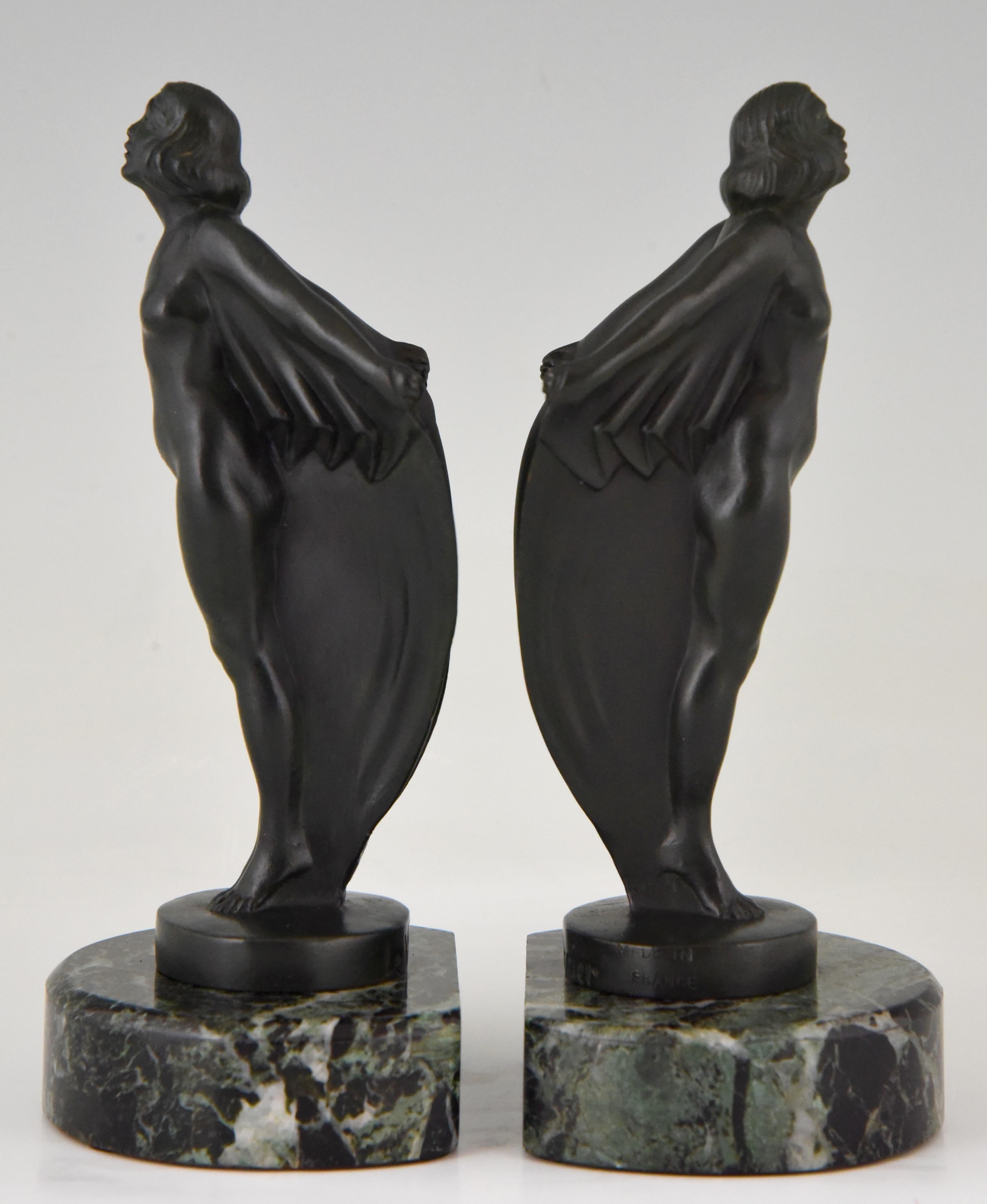 A lovely pair of Art Deco standing nudes with drape by the famous French sculptor Mar Le Verrier. The women are cast in Art metal and have a dark green patina. They are mounted on a green marble base, France, 1930.