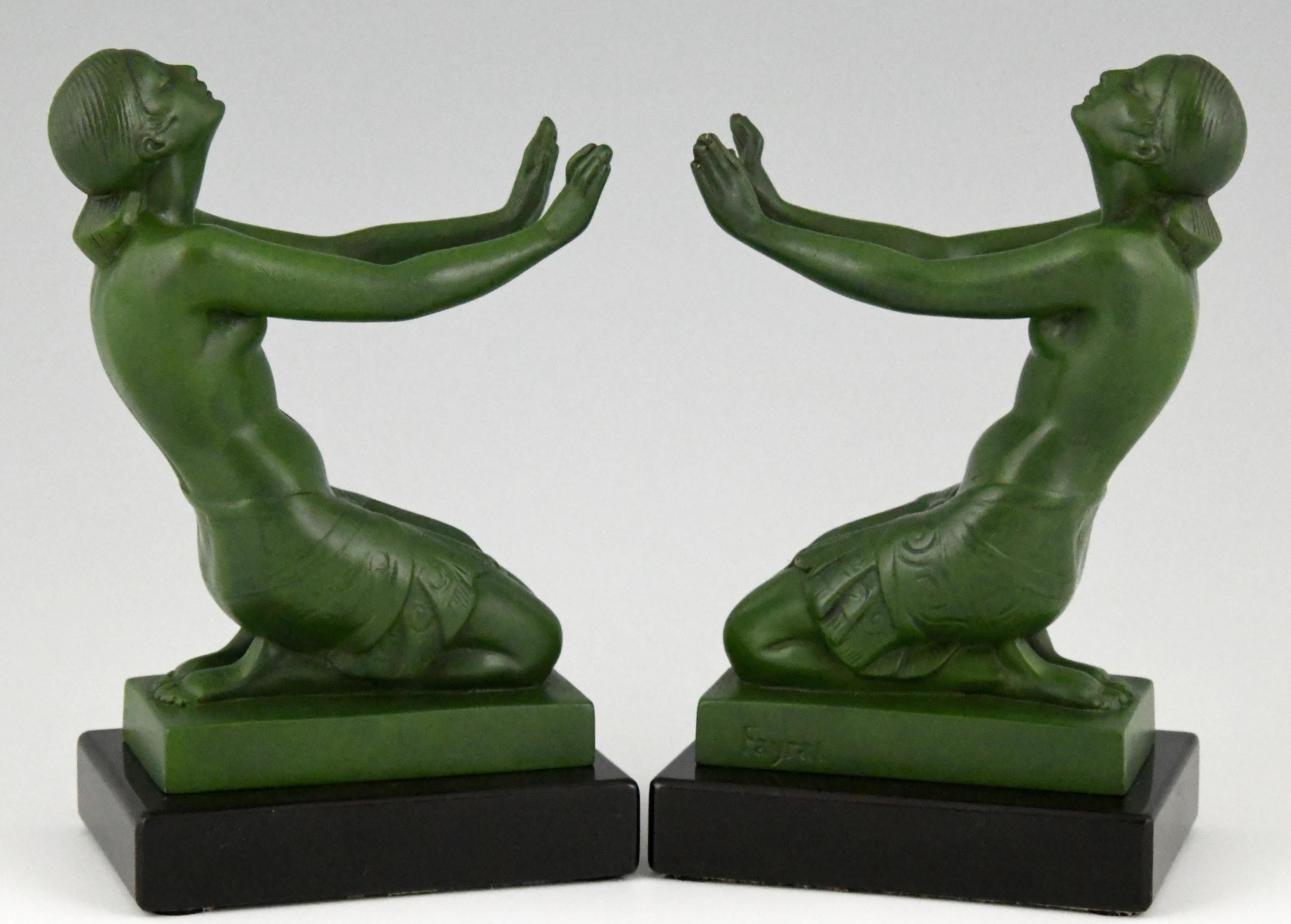 Art Deco figural nude bookends figuring two kneeling women with outstretched arms signed Fayral, this is the pseudonym of Pierre Le Faguays for the models he designed for Max Le Verrier.
France, 1930. Patinated metal on black marble bases.