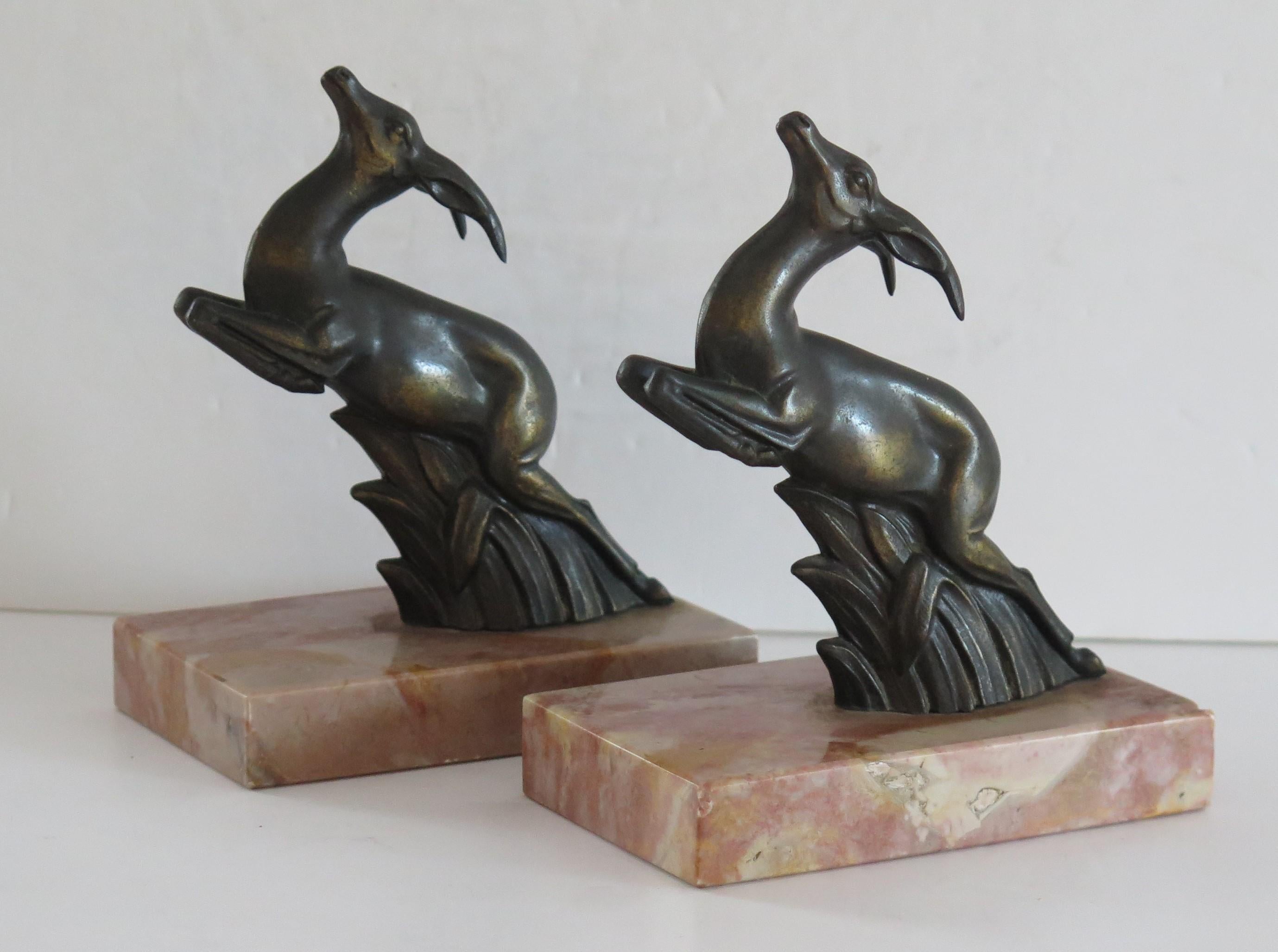 These are a beautiful pair of French, Art Deco period, Book Ends of two metal Springbok Antelopes, in a jumping pose all sat on Italian Marble bases. 

Each antelope has been well modelled with good detail. They are made of metal having a bronzed