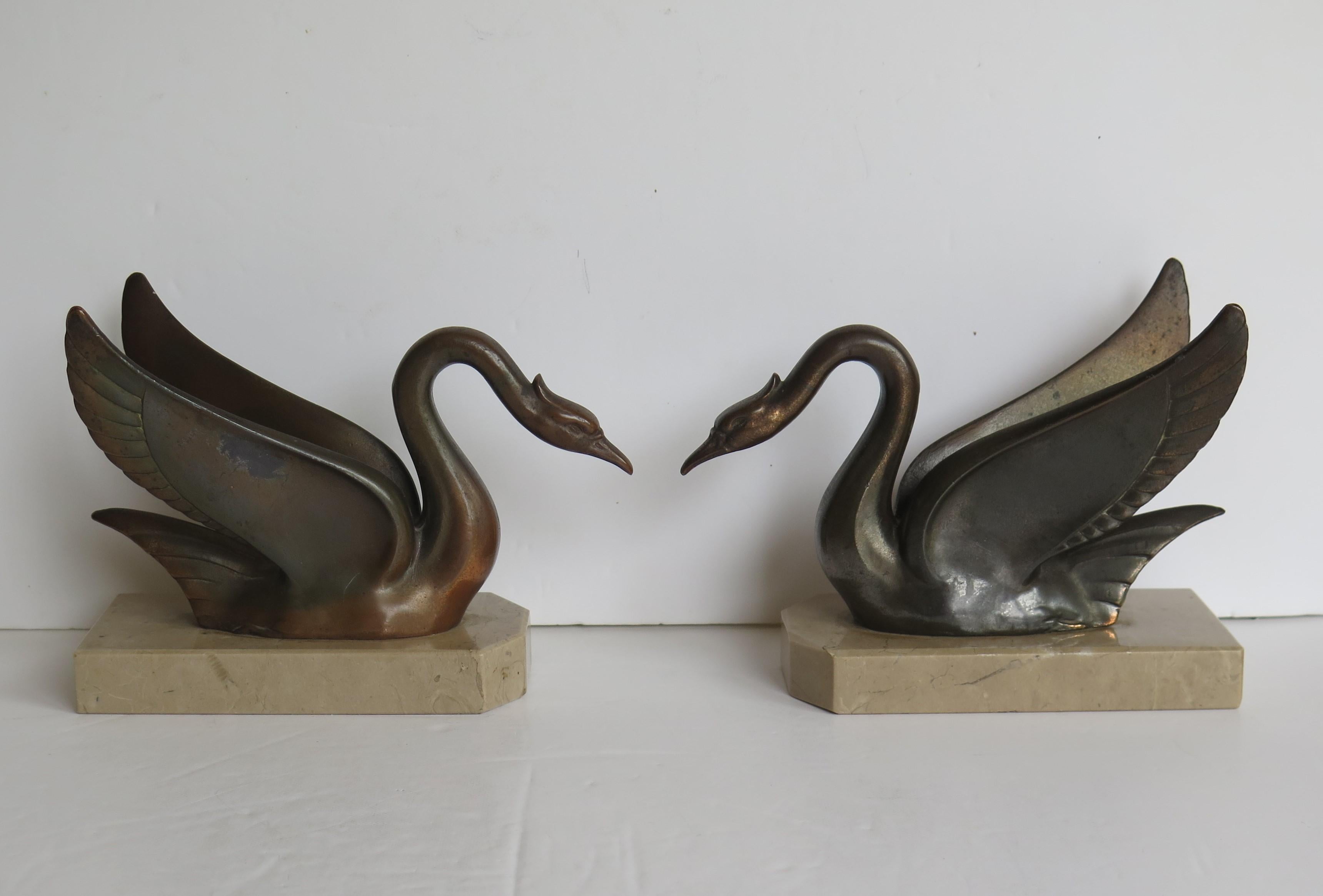 These are a beautiful pair of good quality French, Art Deco period, book ends of two metal bronzed swans on marble bases. 

Each swan has been well modelled with good detail and then cast in a metal, possibly spelter, having a bronzed finish.