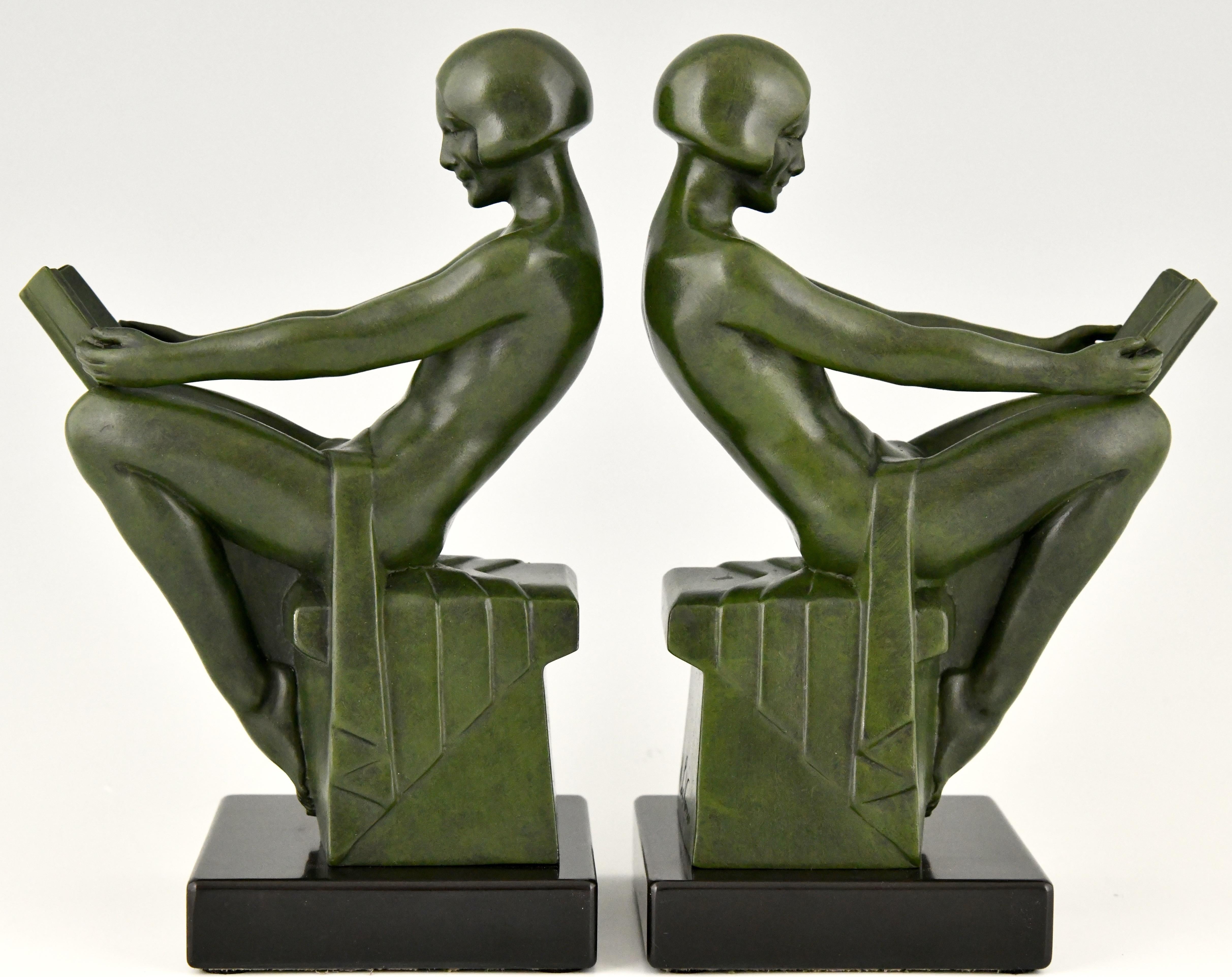 A pair of Art Deco bookends with reading nudes by Max Le Verrier, France ca. 1930. The Art metal sculptures have a lovely green patina and are mounted on black marble bases. Literature:
