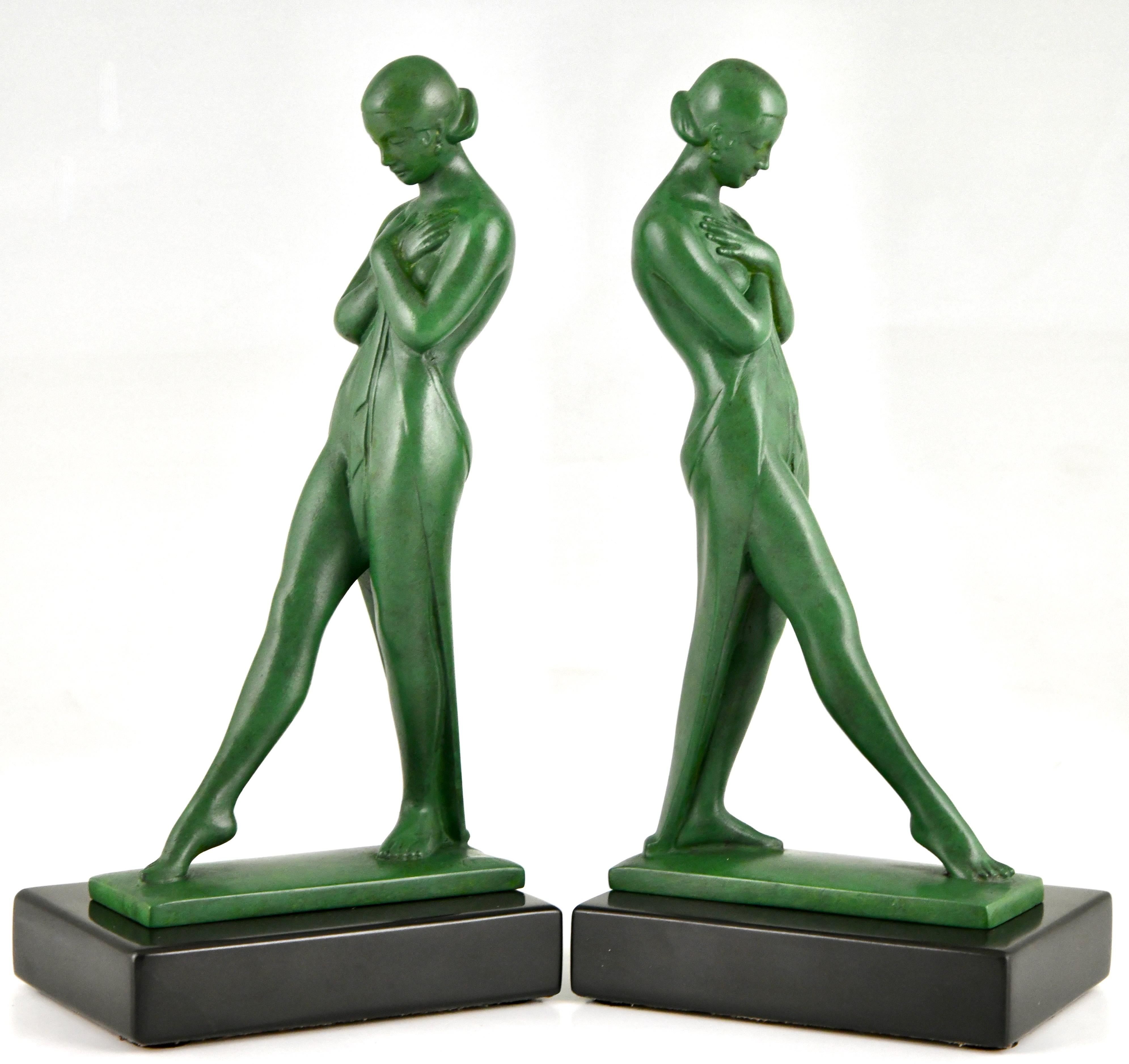 Art Deco bookends with standing nudes Meditation
Signed by Fayral, pseudonym of Pierre Le Faguays. 
Cast at the Max Le Verrier foundry, France ca. 1930
Art Metal with green patina on Belgian Black marble base. 

Literature:
Bronzes, sculptors and
