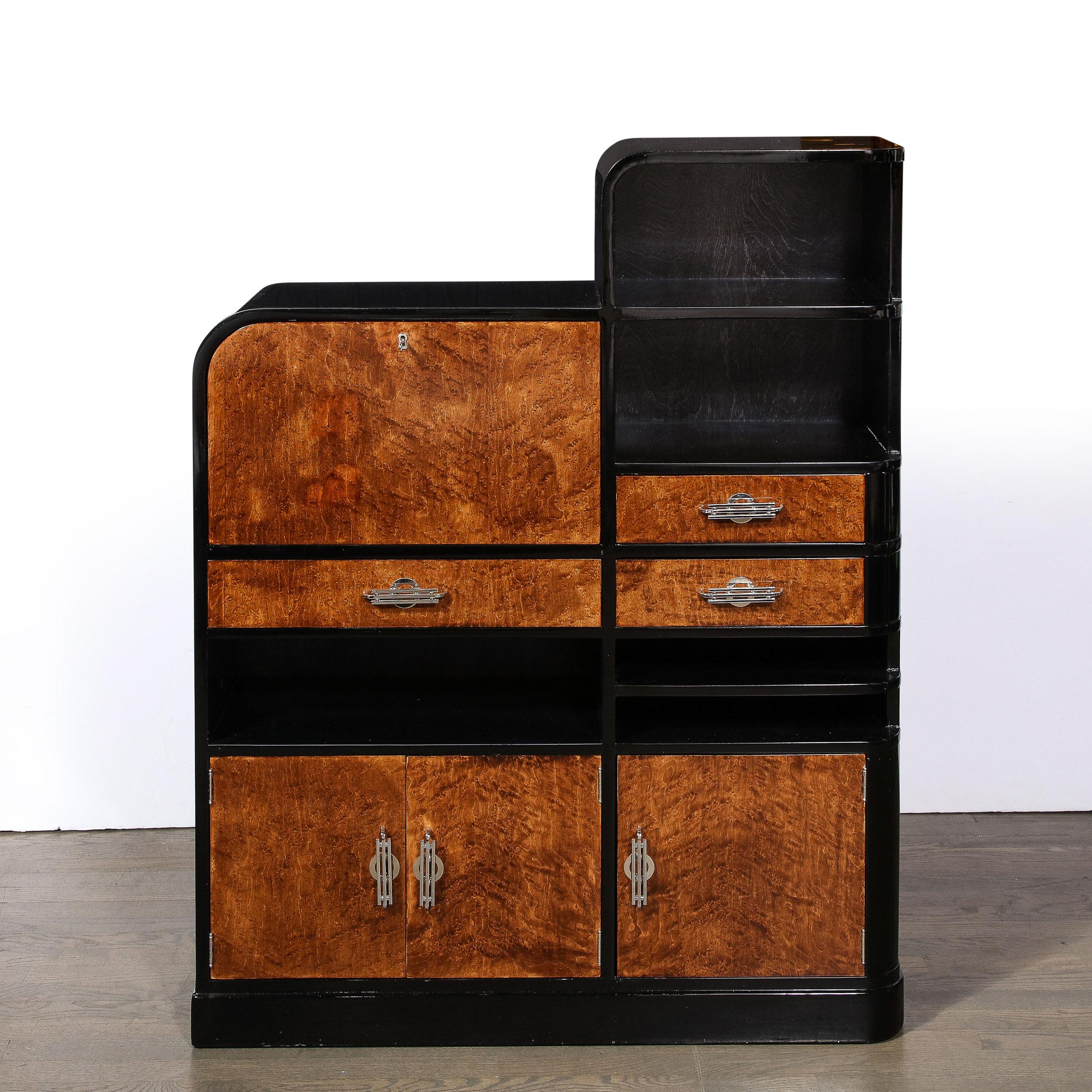 The Art Deco Secretary Bookcase is a beautiful example of American Streamline art and architecture, originating from the United States Circa 1935. The piece features elegant drawers, pulls and lines as well as wonderful materiality in the burled and