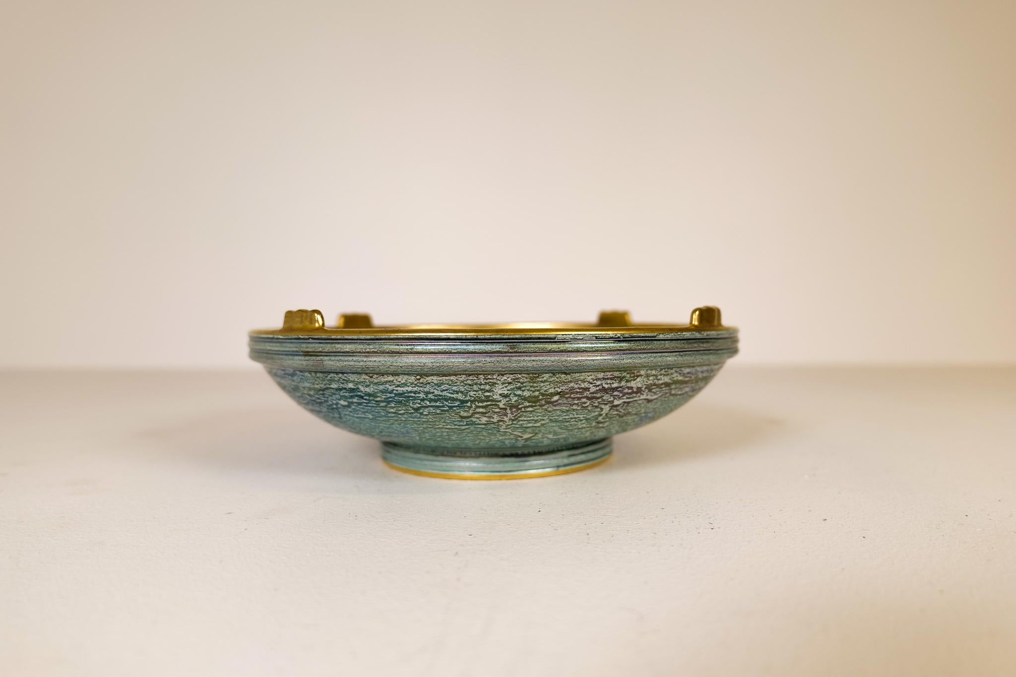 A wonderful bowl created by Josef Ekberg and manufactured by Gustavsberg Sweden in 1920s. Wonderful green glaze with hand painted gold pattern on the bowl. 

Very good vintage condition. 

Dimension: Diameter 27 cm height 9 cm.
 