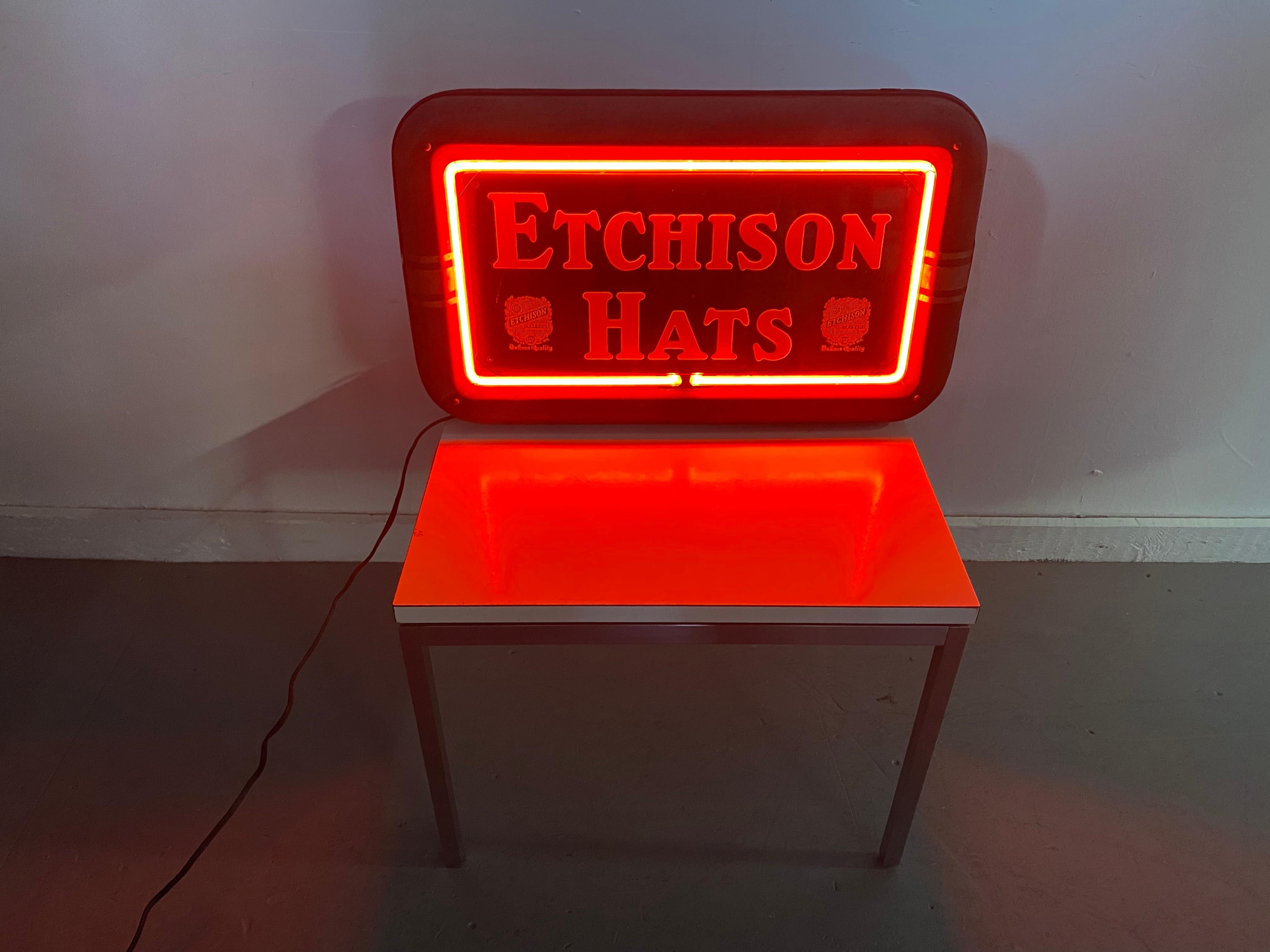 Art Deco Box Neon sign advertizing Etchison Hats,c.1930's,, wonderful red neon, made by The Neon Shop.Lima Ohio.. Great graphics..retains original black metal housing.. curved deco design speed lines.. Red neon appears to be original..