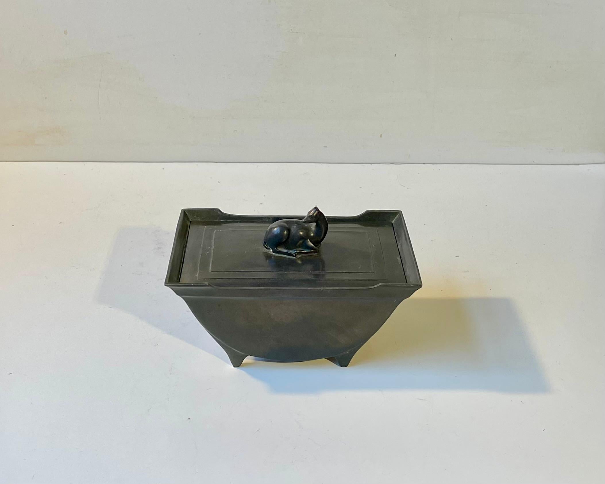 A stylish relatively large box with an ear-less deer decorating the removable lid. Distinct Art Deco styling. Designed and made by Just Andersen in Denmark circa 1930-40. Design number: D30. Disko-metal is Just Andersen own invention/alloy.