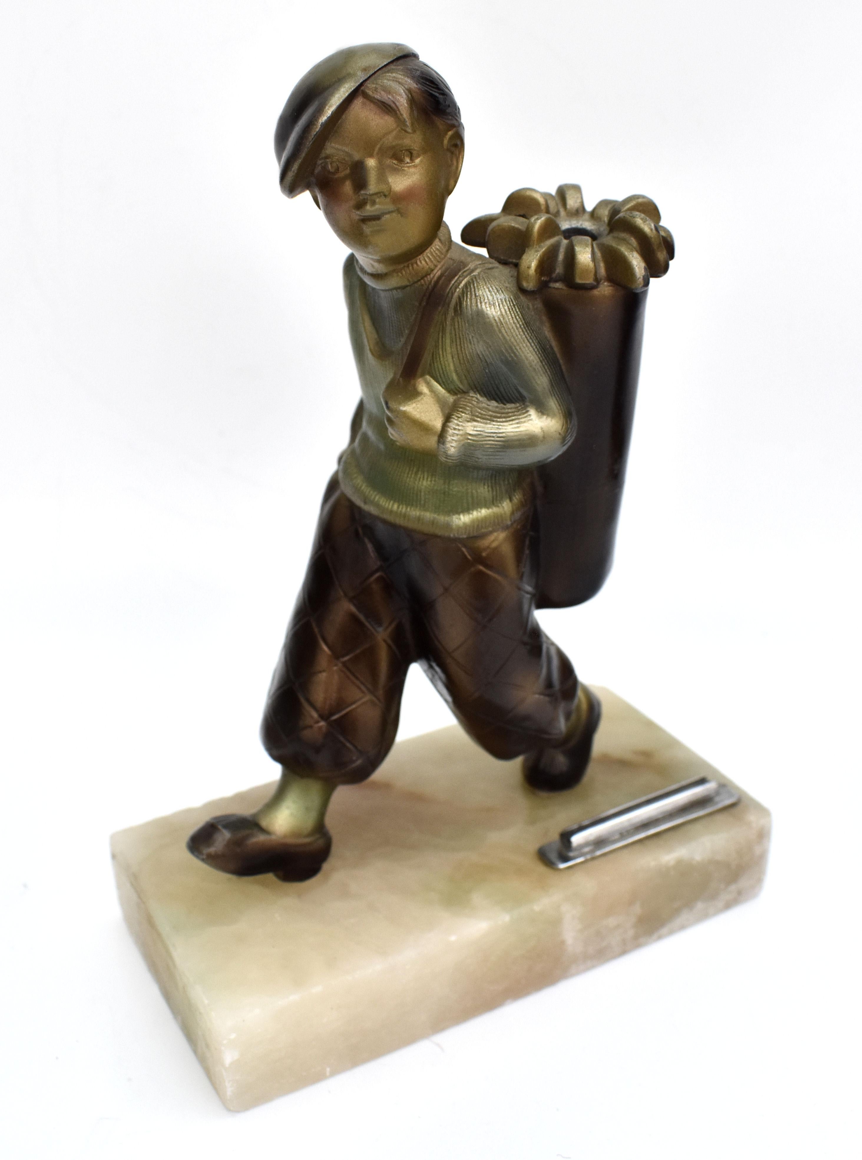 An Art Deco patinated at metal figural table lighter of Boy Golfer on an Onyx base. Made by the austrian sculpture Joesef Lorenzl.
The striker wand is missing but the rest of the figure is in great condition with just expected but minimal signs of