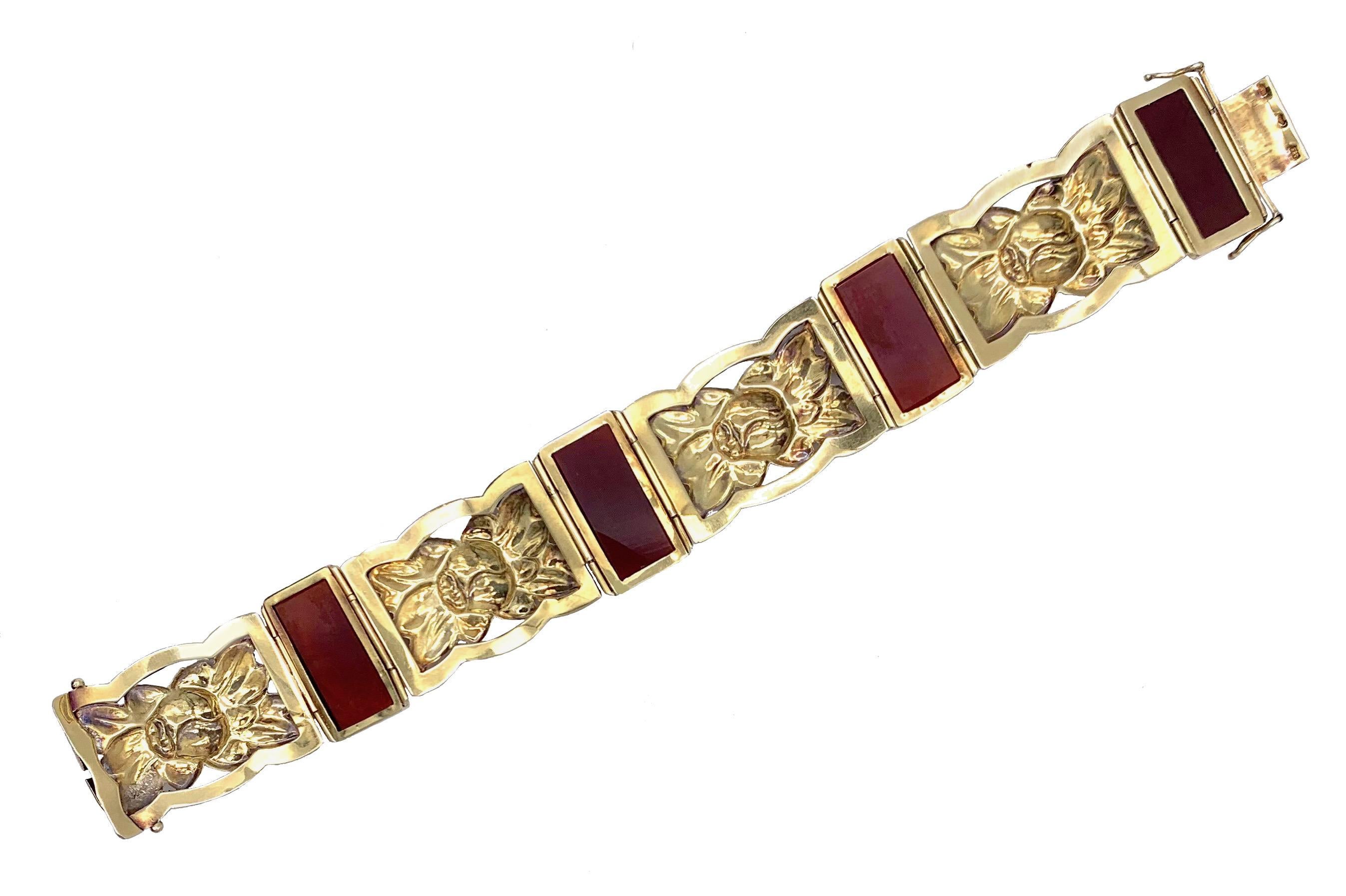 This fine Art Deco bracelet has been made by a Viennese Goldsmith in the 1920's out of 14 karat gold. Four repoussé elements decorated with flowers and leaves alternate with four rectangular plaques of carved carnelian. The bracelet has been much