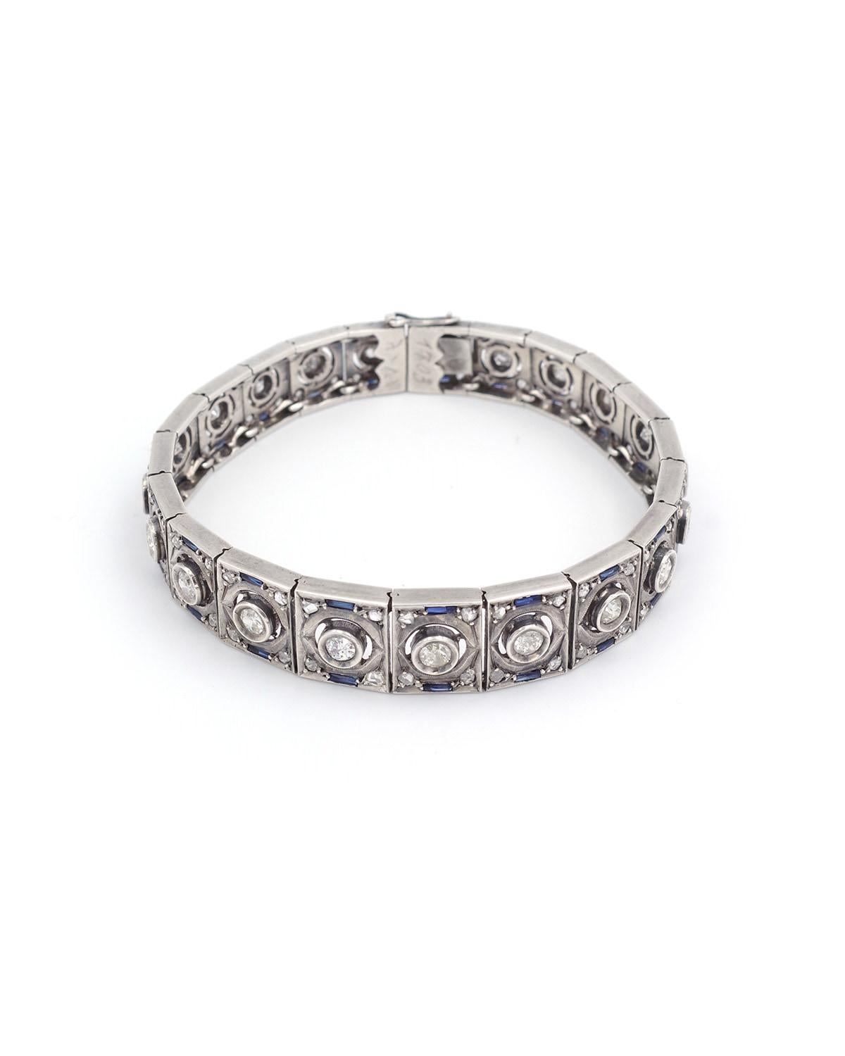 Art Deco sapphire bracelet in silver. Bracelet with geometric lines typical of the Art Deco period. This bracelet is set with 21 old-cut diamonds, framed by small rose-cut diamonds and baguette-cut synthetic sapphires. The estimated weight of the