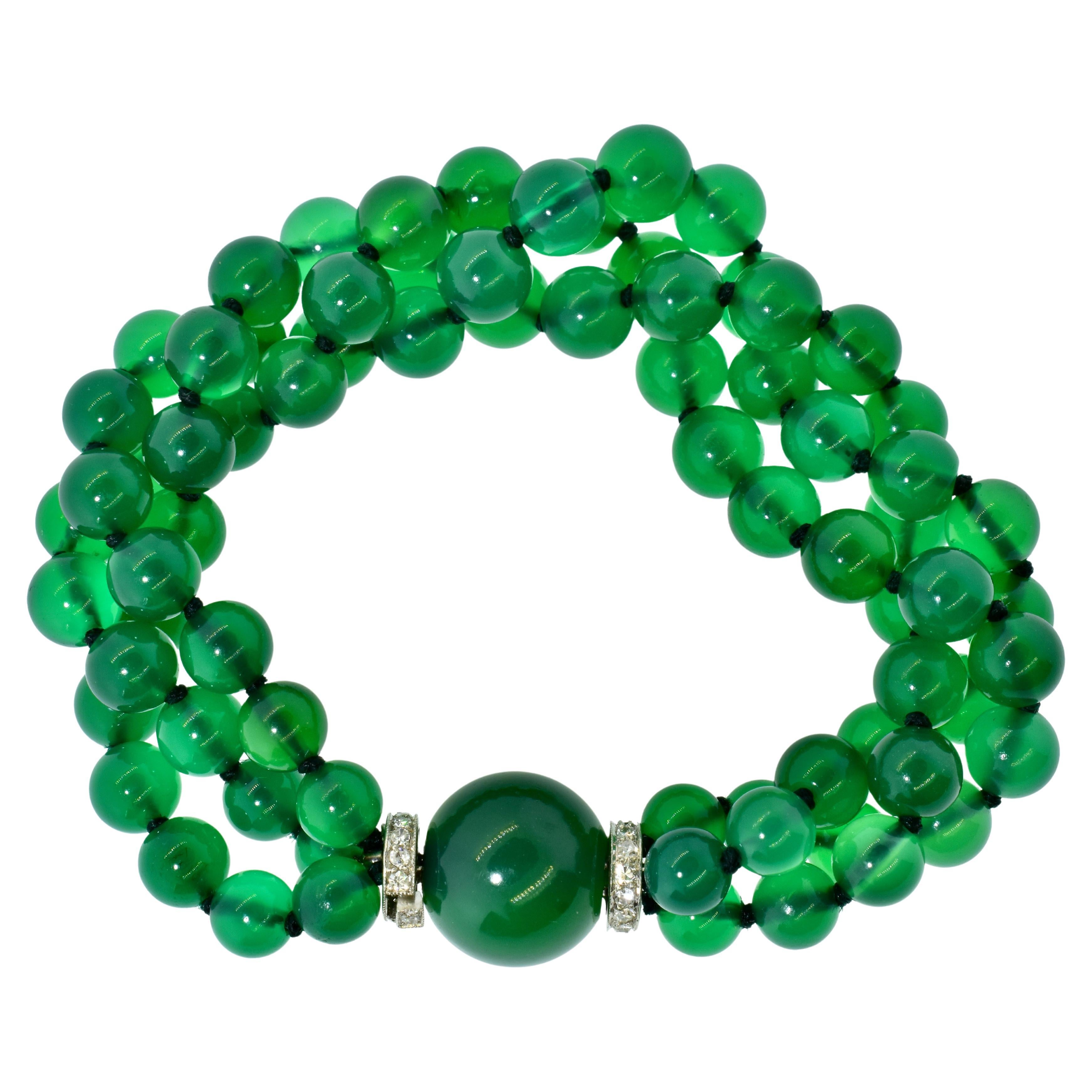 Art Deco bracelet composed of Chrysoprase  (also called green onyx), diamonds and platinum.  This colorful bracelet possesses 6 to 7 mm. green onyx beads terminating with a large 13.32 mm Chrysoprase bead and diamond rondels at the platinum clasp