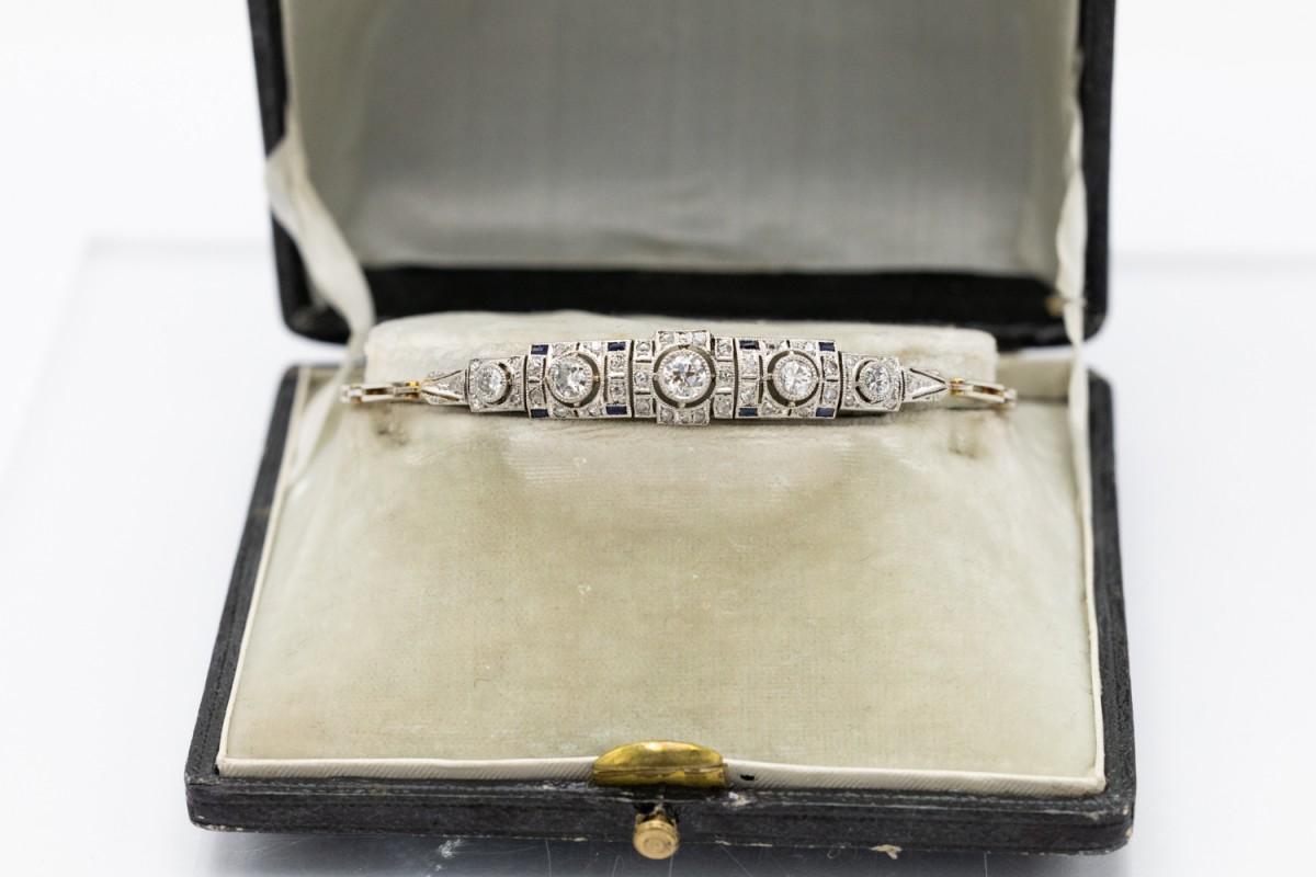Art Deco bracelet made of 14-karat gold (0.585 fineness) and platinum set with diamonds and sapphires.

Origin: Czechoslovakia circa 1920s and 1930s. Hallmark preserved.

Geometric bracelet decorated with 41 diamonds in old brilliant and rose cut,
